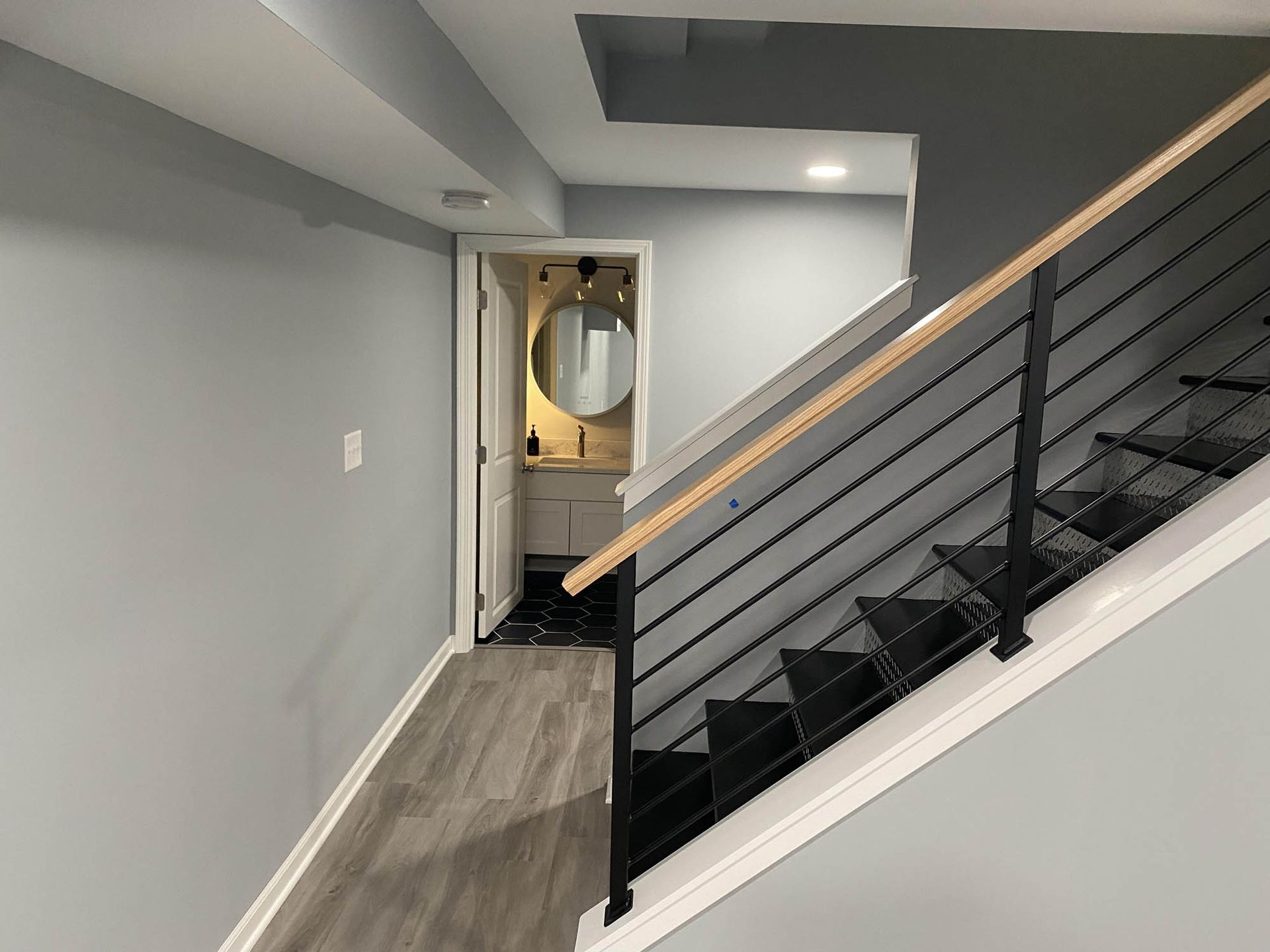 A staircase leading up to a bathroom in a basement.