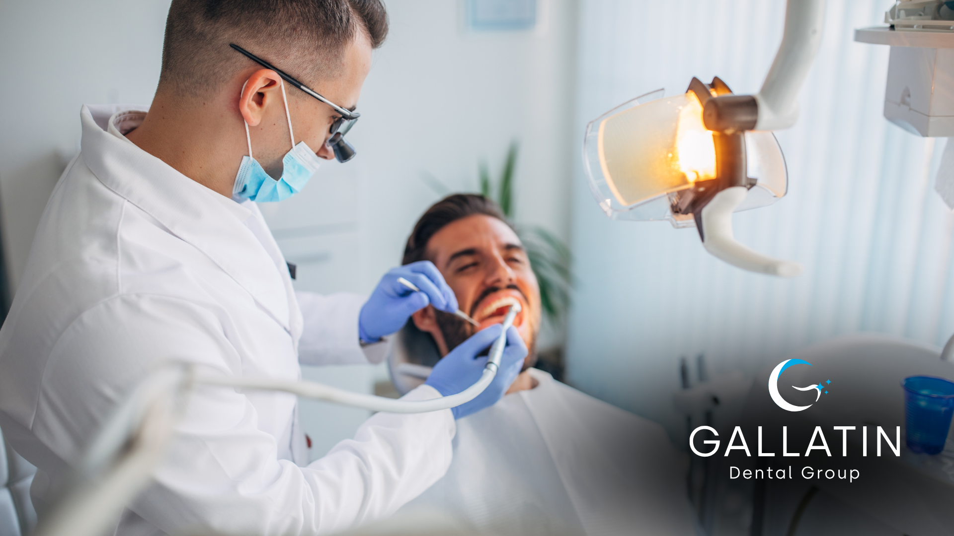 A dentist is examining a man 's teeth in a dental office.