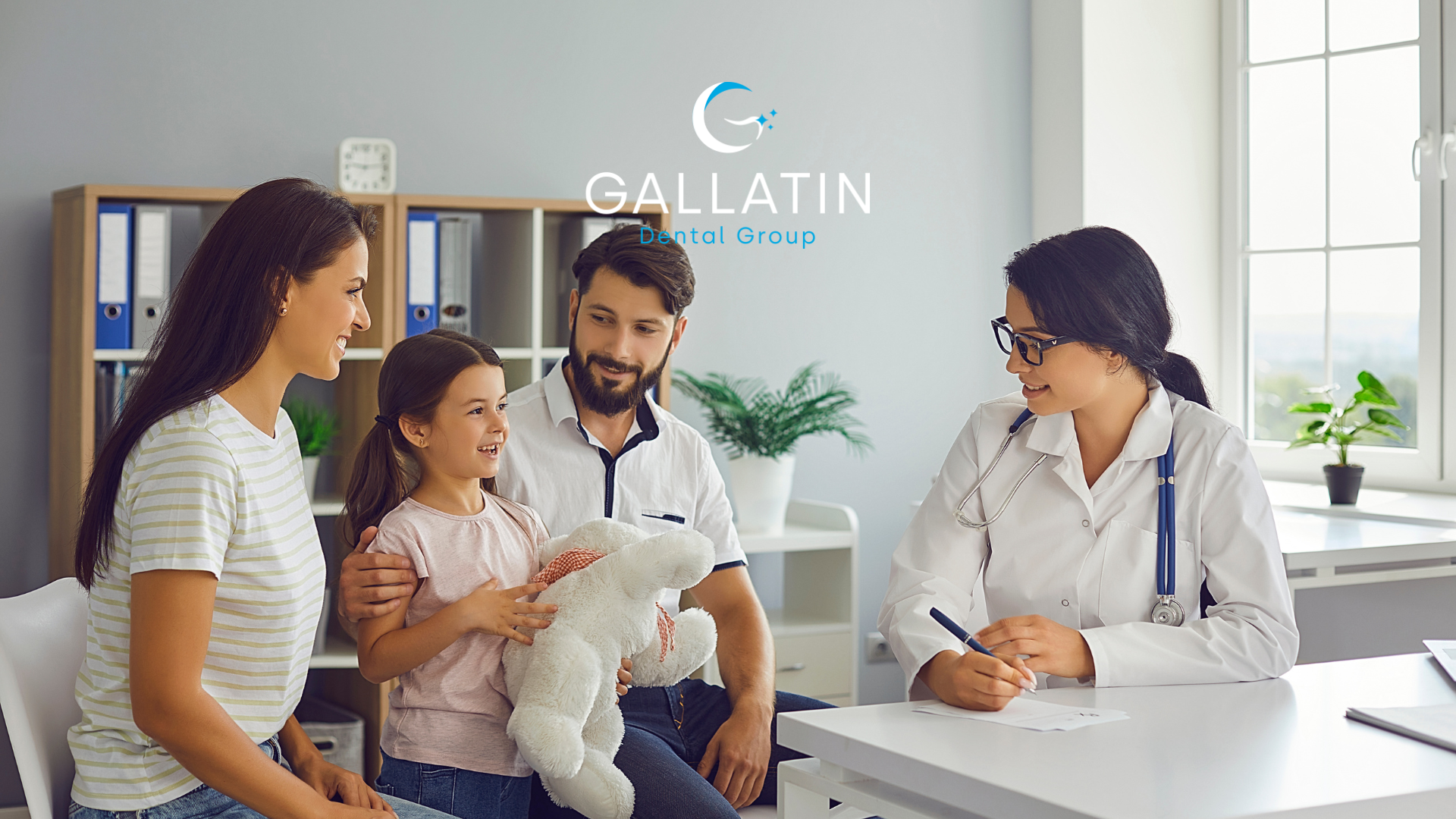 A family is sitting at a table talking to a doctor.