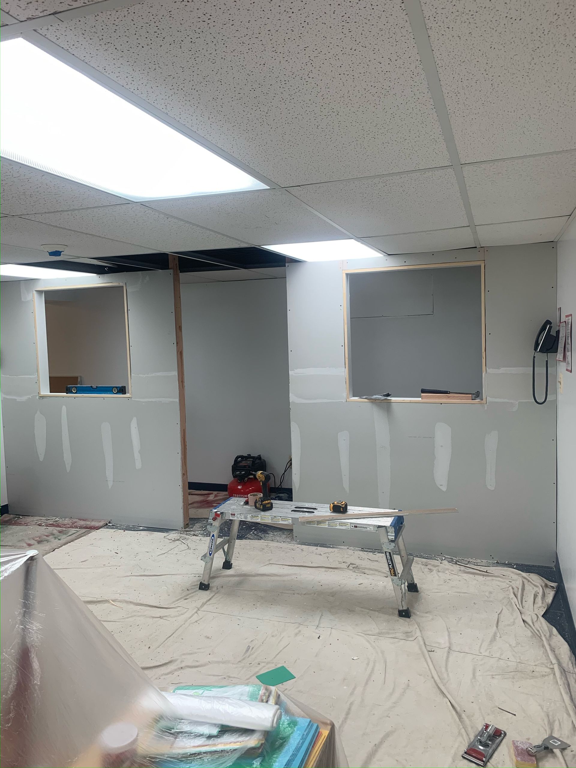 A room that is being remodeled with a table in the middle of the room.