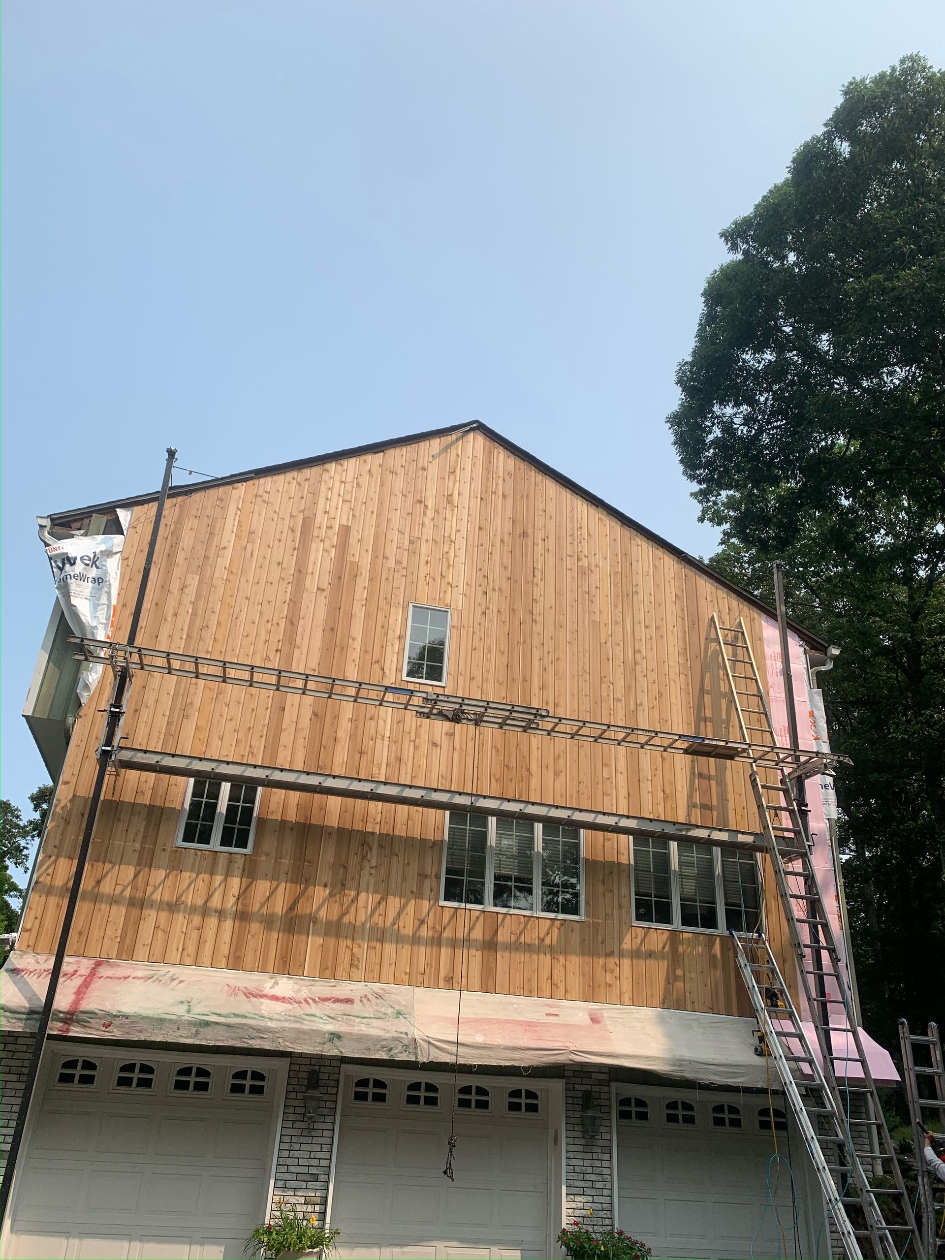 A large house with a lot of windows is being remodeled.