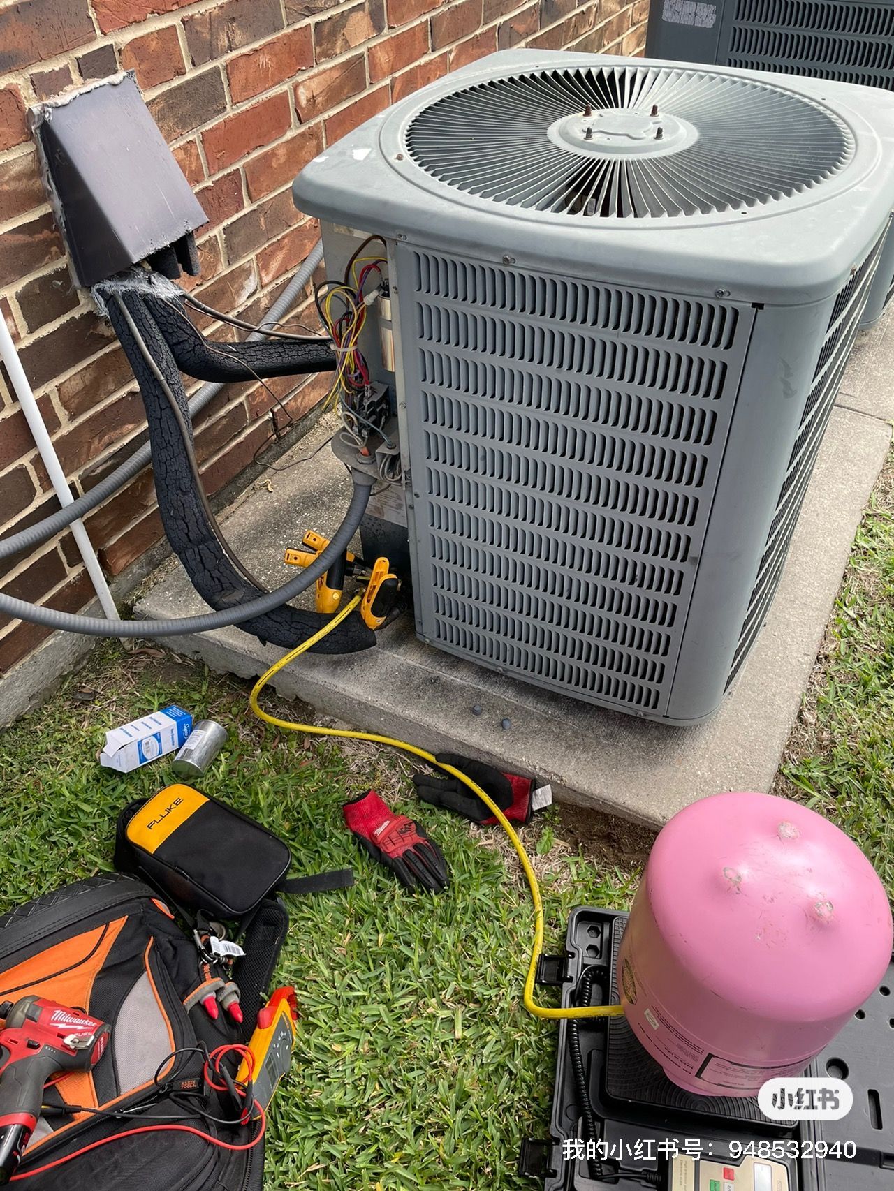 HVAC unit being serviced outdoors, tools and equipment present.