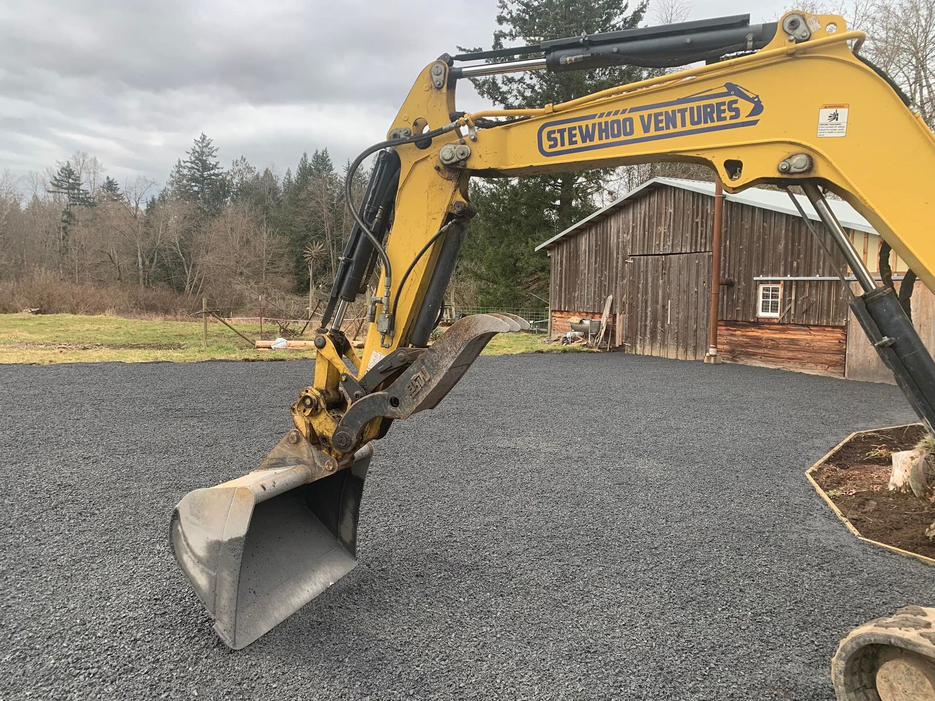 Yellow dump truck loaded with rocks in a warehouse.