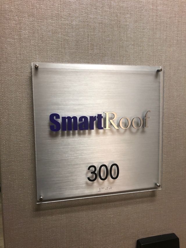 SmartRoof wall sign with blue and gray lettering and room number 300