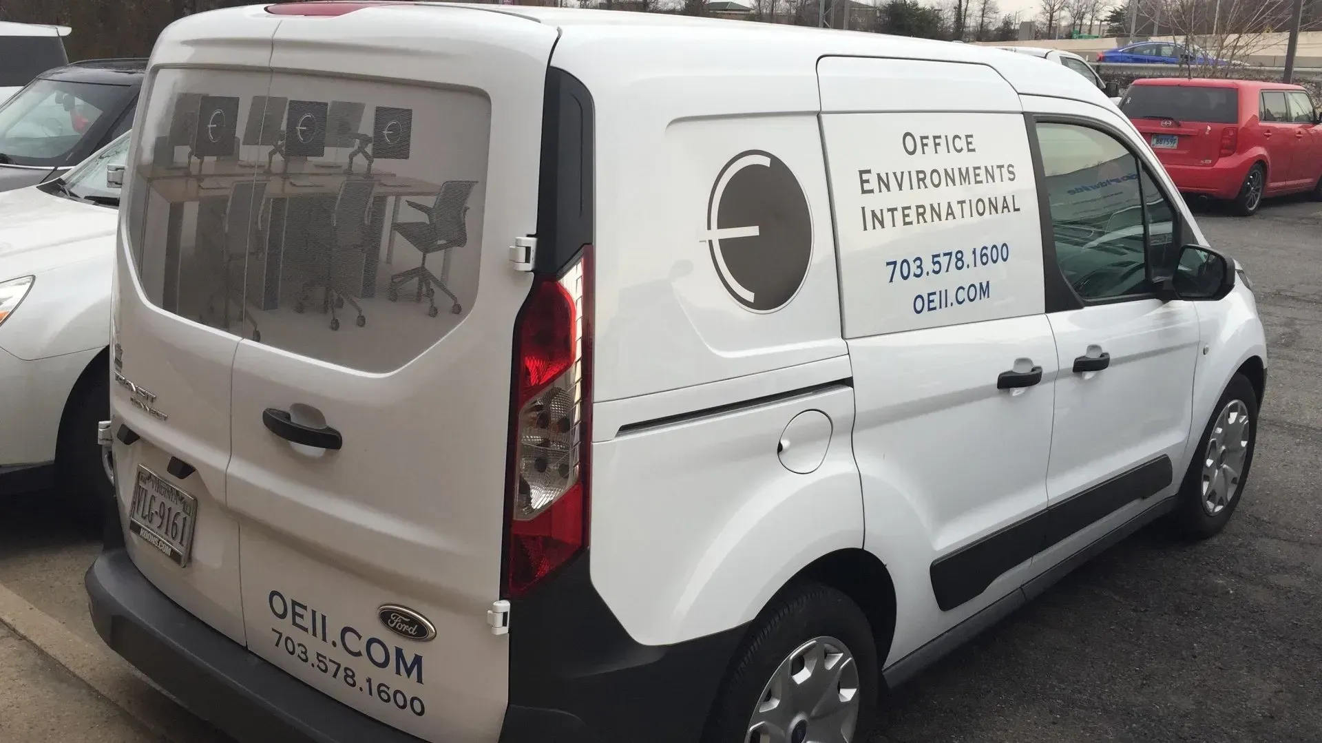 A white cargo van parked in a lot, featuring