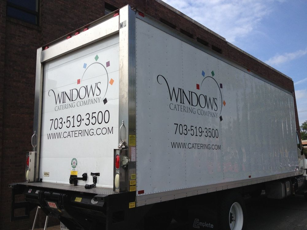 White delivery truck for Windows Catering Company with branding, phone number, and website on the side and back.