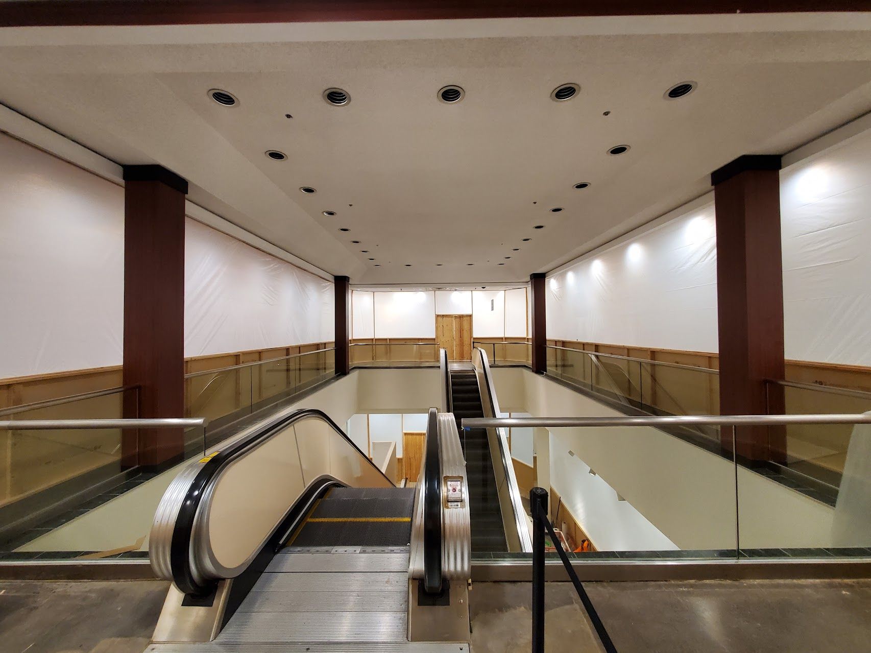 A large empty building with escalators and stairs