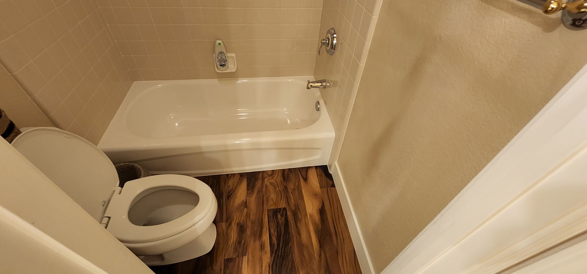 There is a toilet and a bathtub in the bathroom.