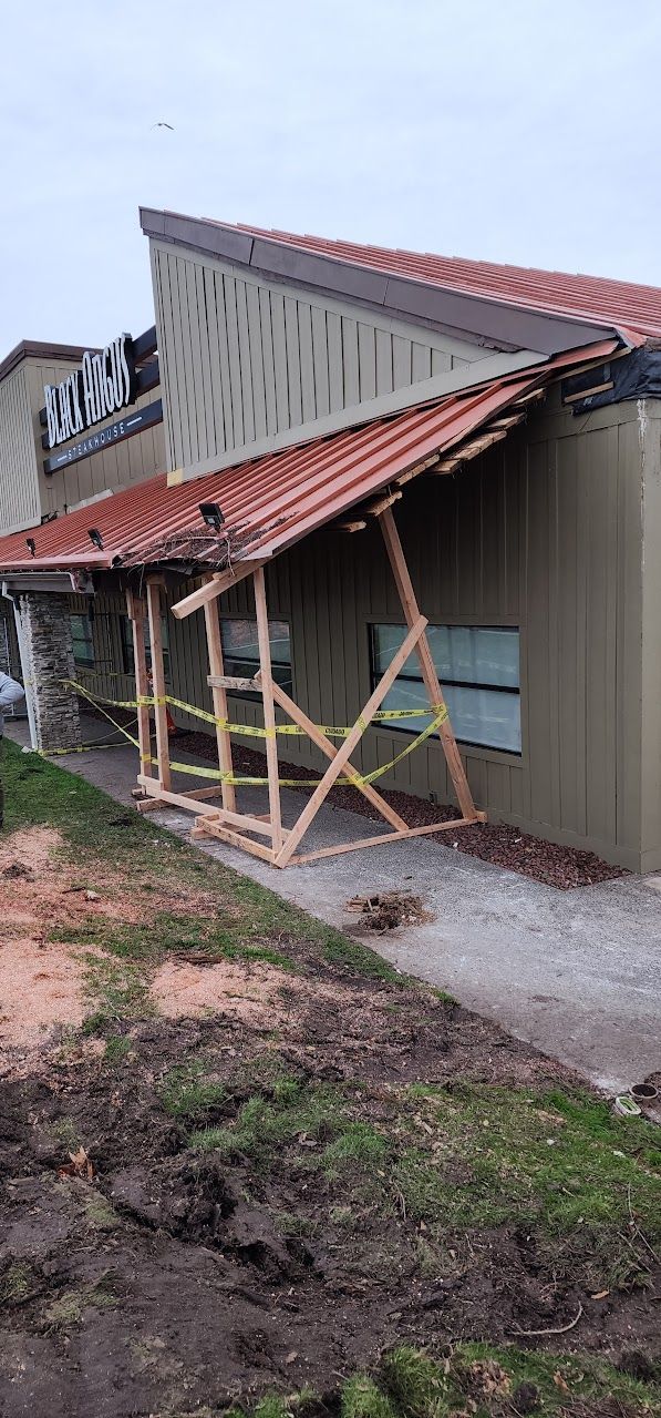 A building with a roof that has been damaged by a storm.