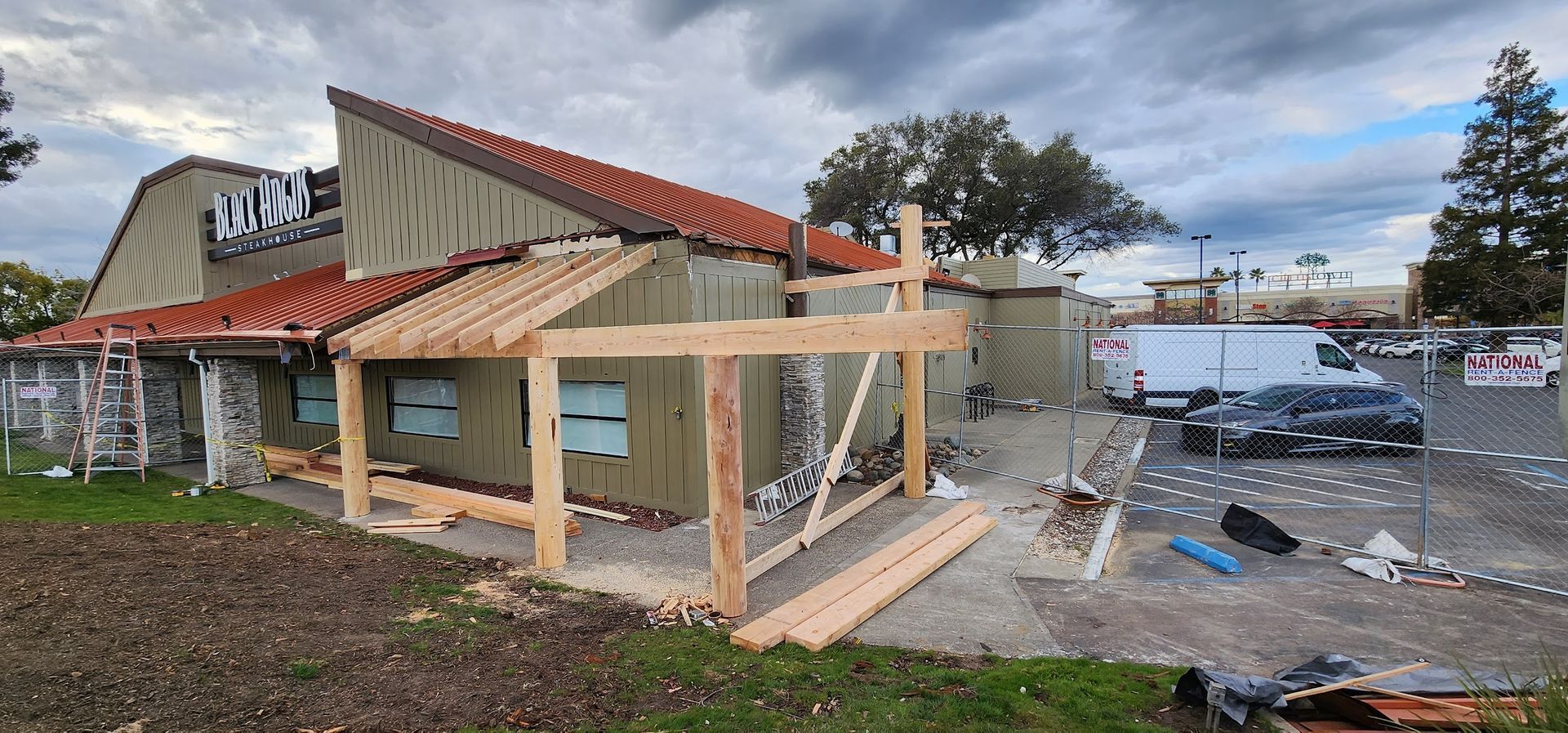 A wooden structure is being built on the side of a building.