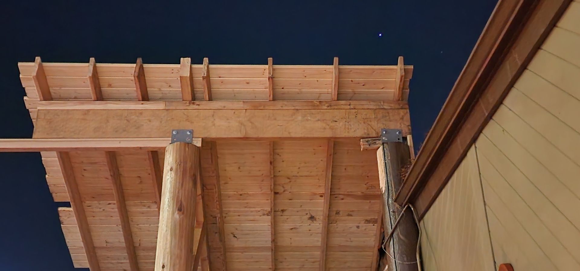 A wooden structure is being built on top of a building.