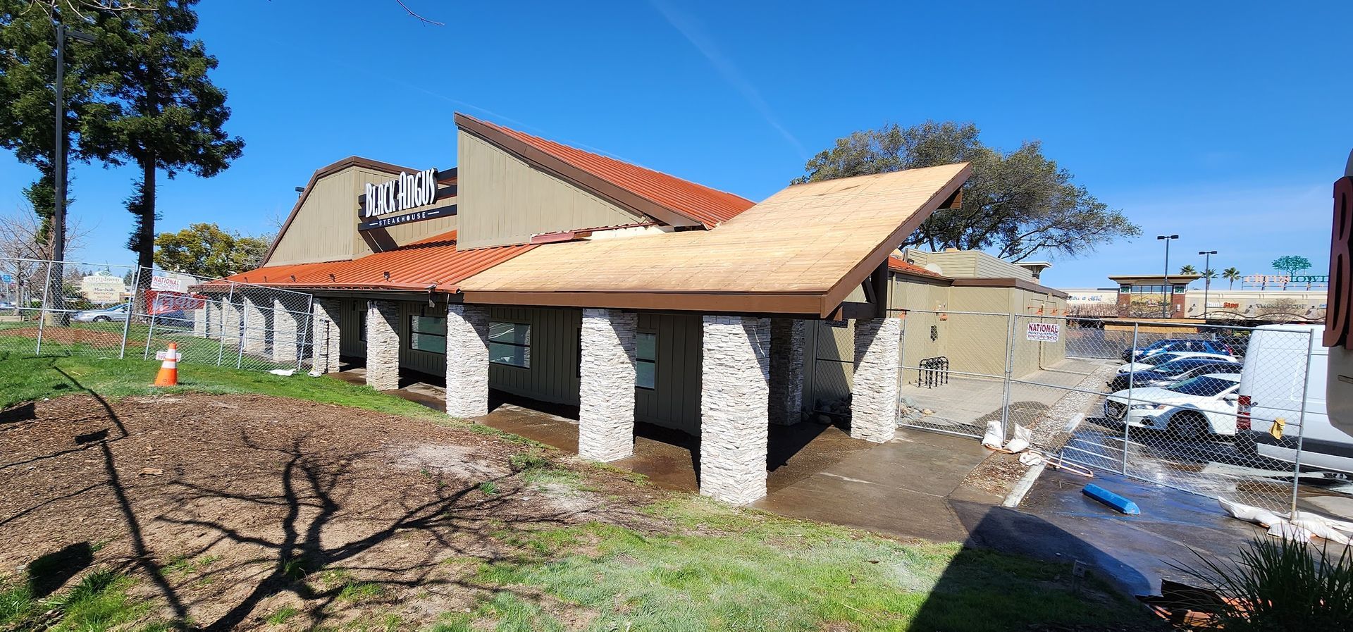 A large building with a wooden roof is being built.