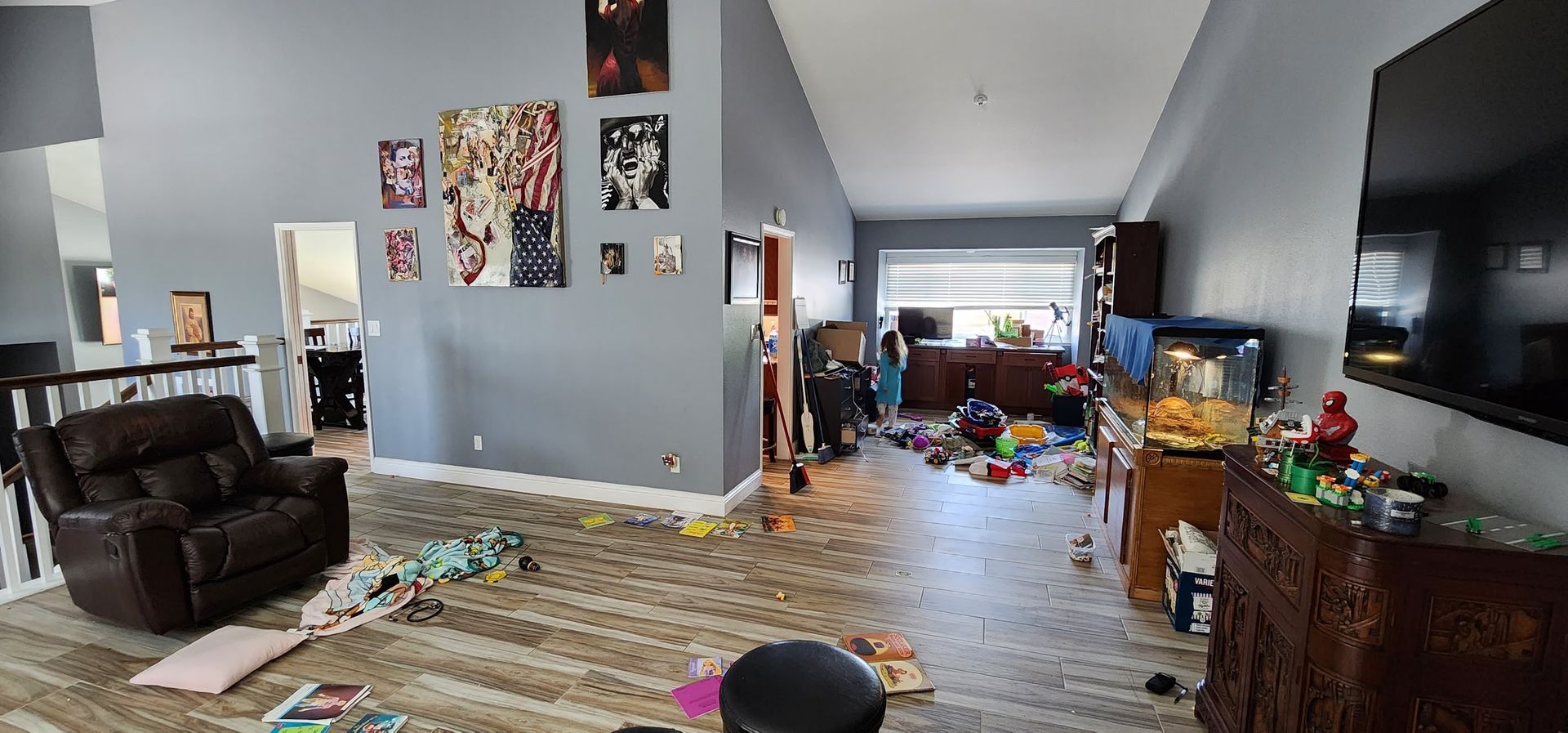 A living room filled with lots of toys and a television.