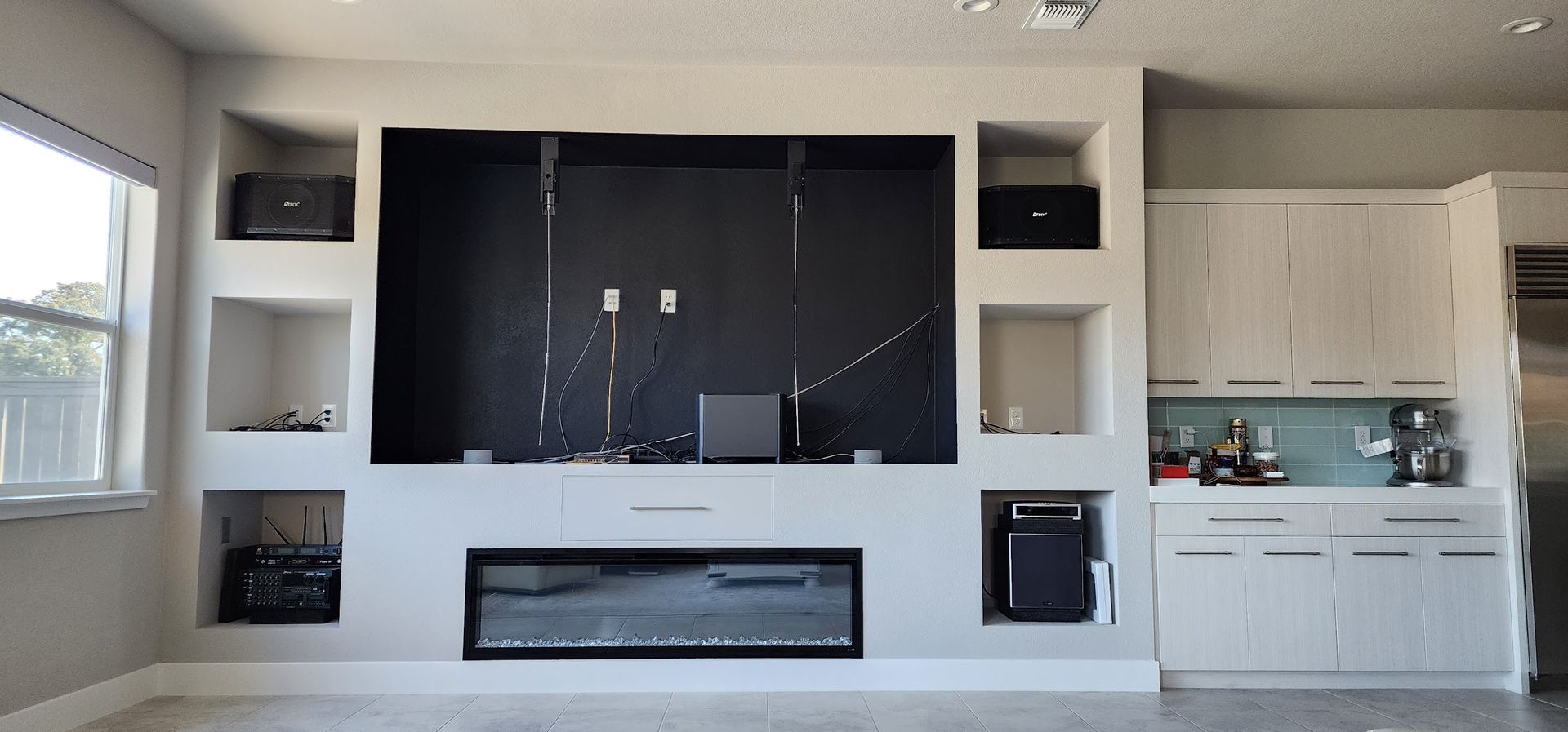 A living room with a fireplace and lots of shelves