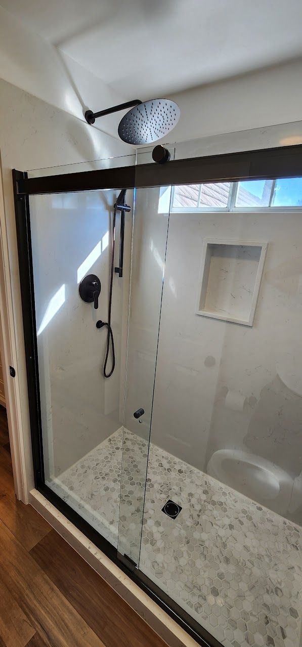 A bathroom with a walk in shower and a bathtub.