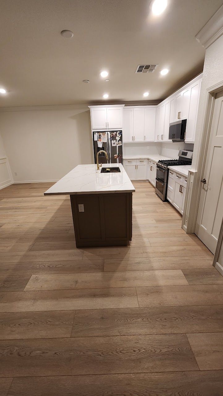 There is a large island in the middle of the kitchen.