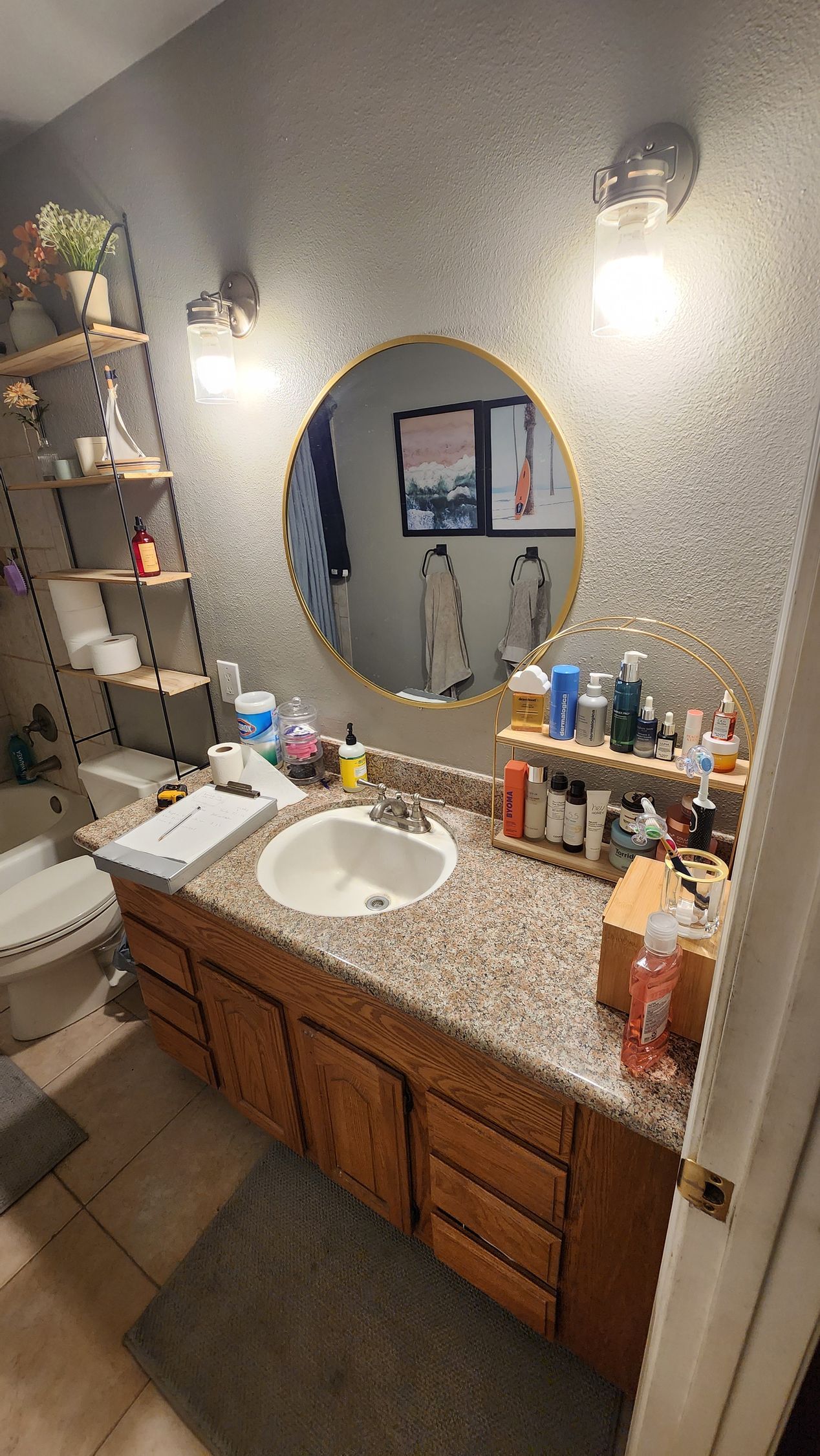 A bathroom with a sink , toilet and mirror.