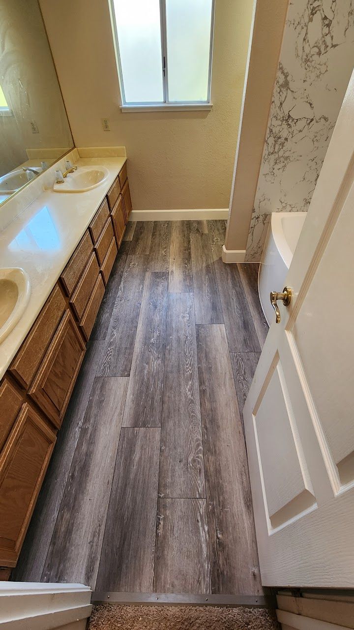 A bathroom with two sinks , a tub and a mirror.