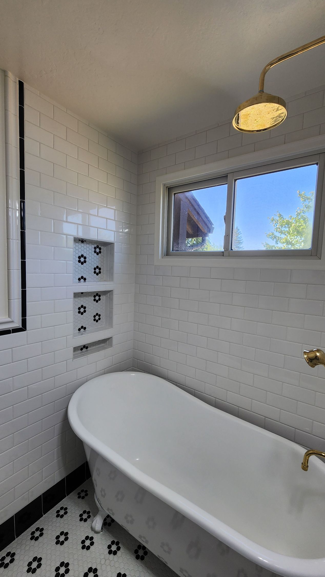 There is a bathtub in the bathroom with a window.