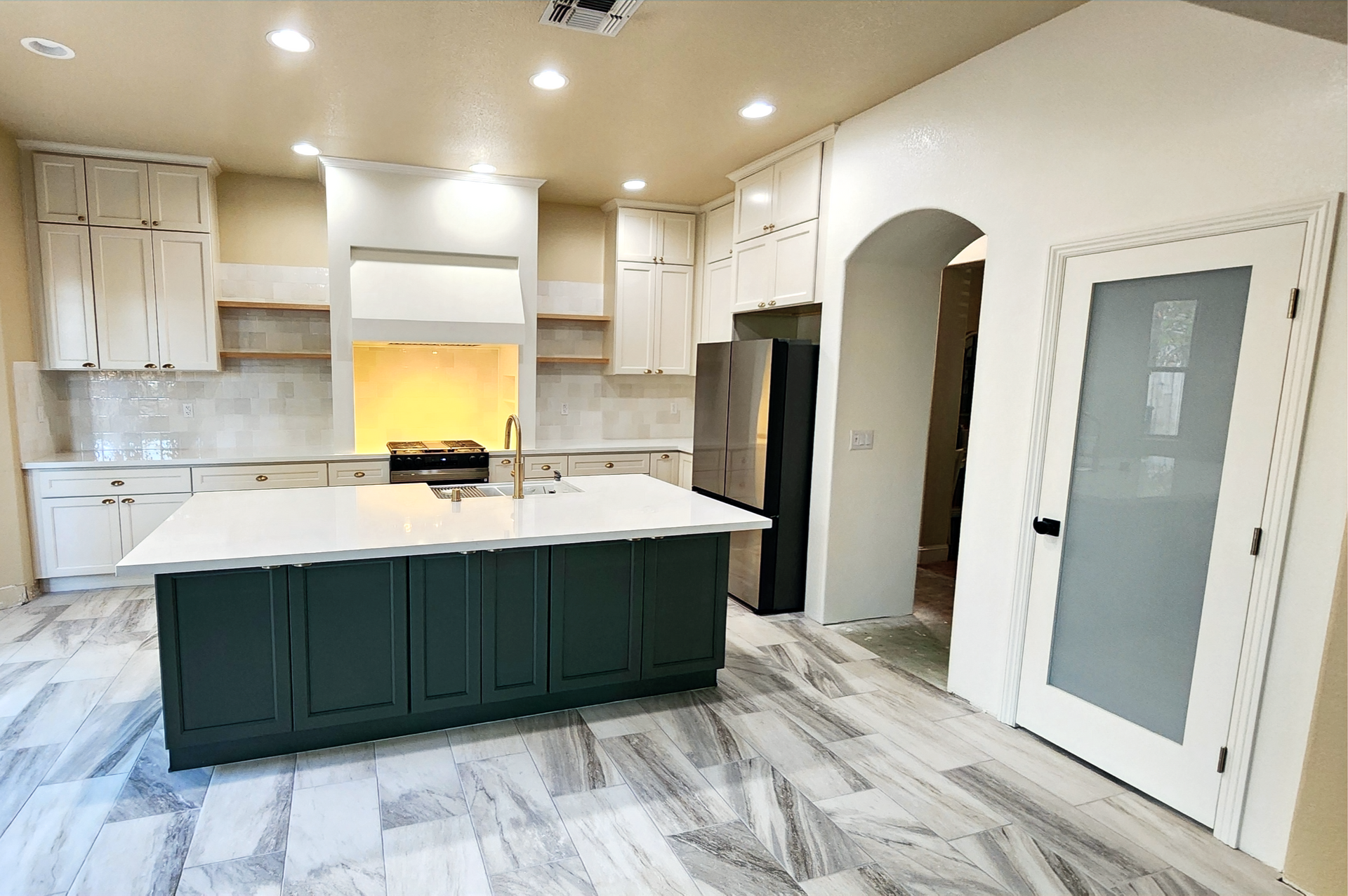 There is a large island in the middle of the kitchen.