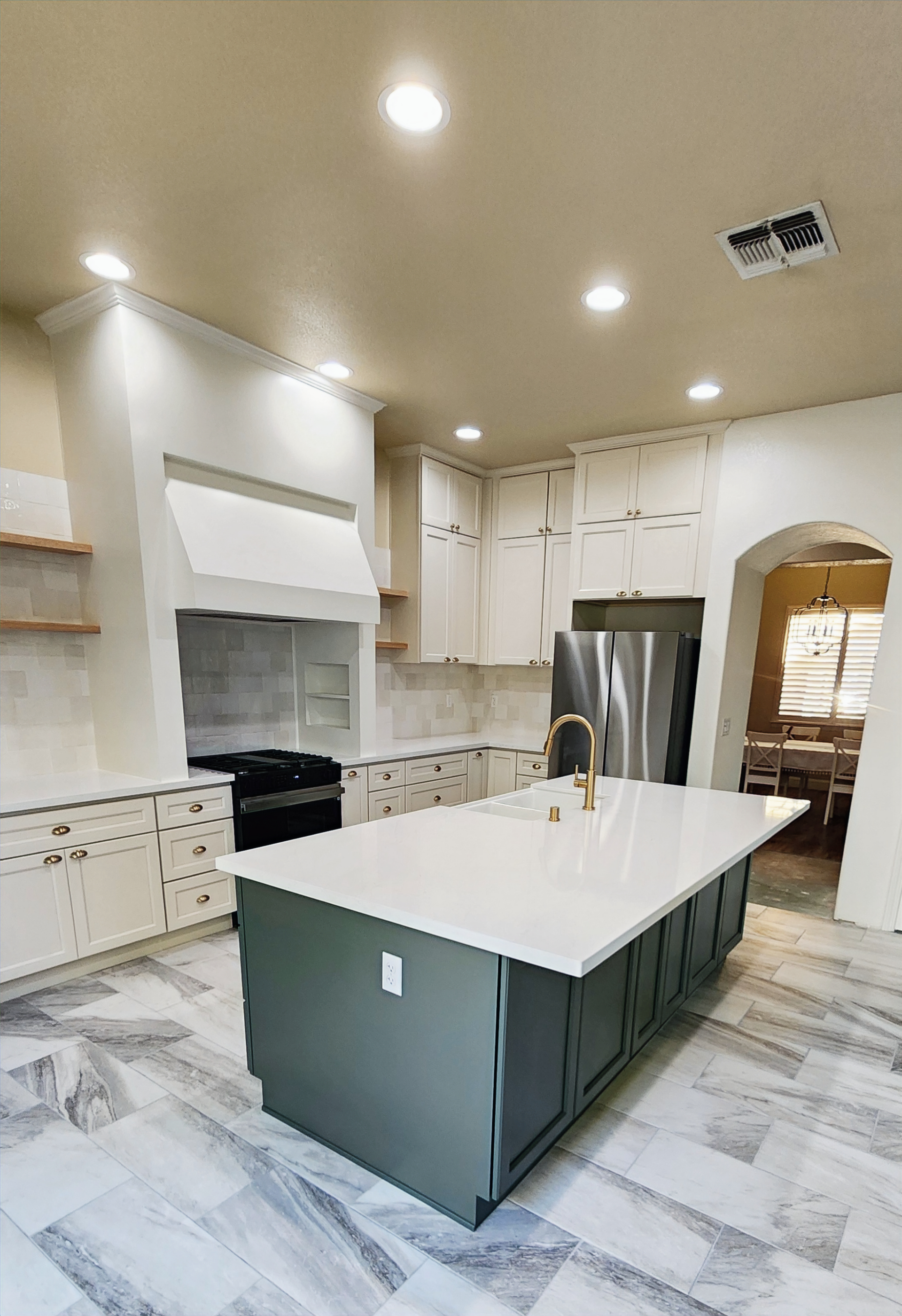 A kitchen with a large island in the middle of it.