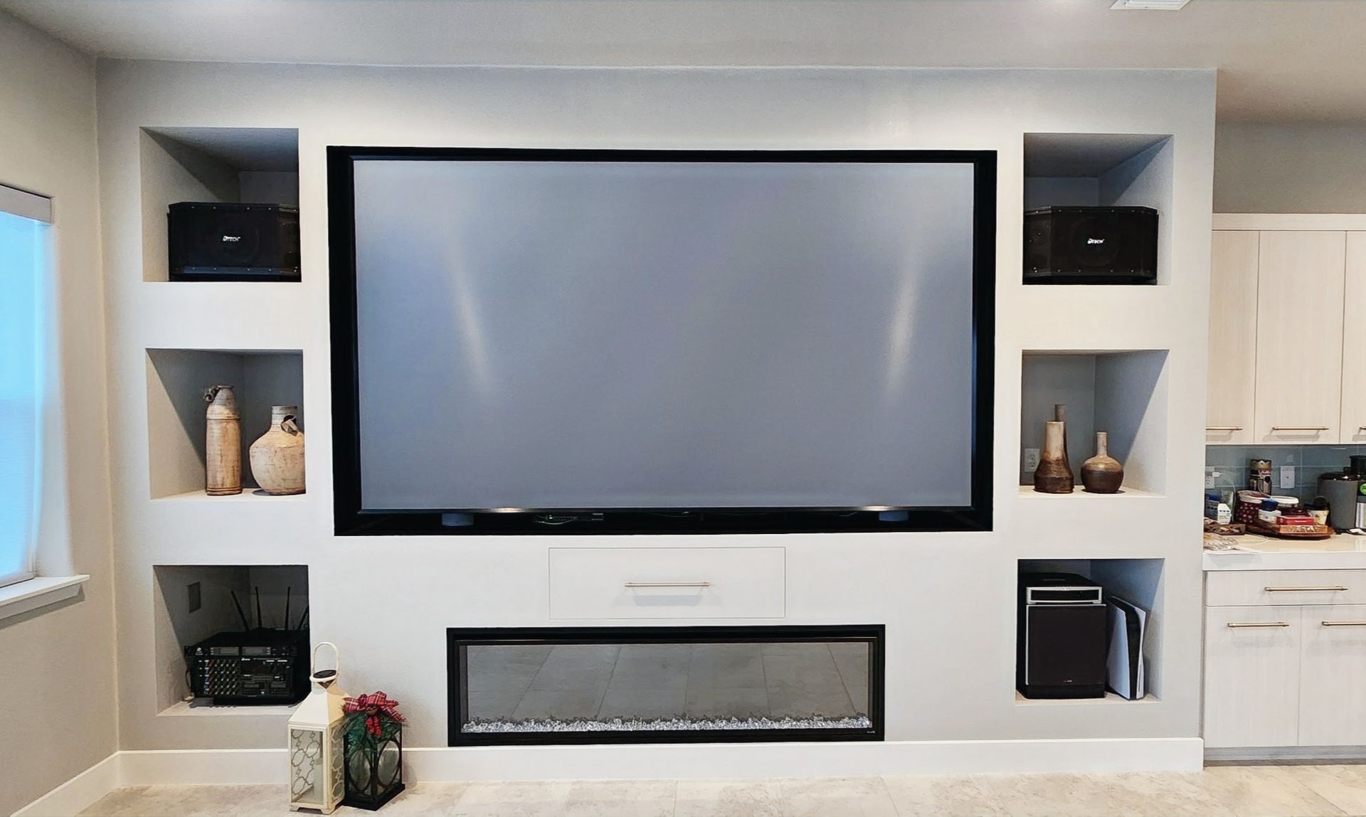A living room with a fireplace and a flat screen tv