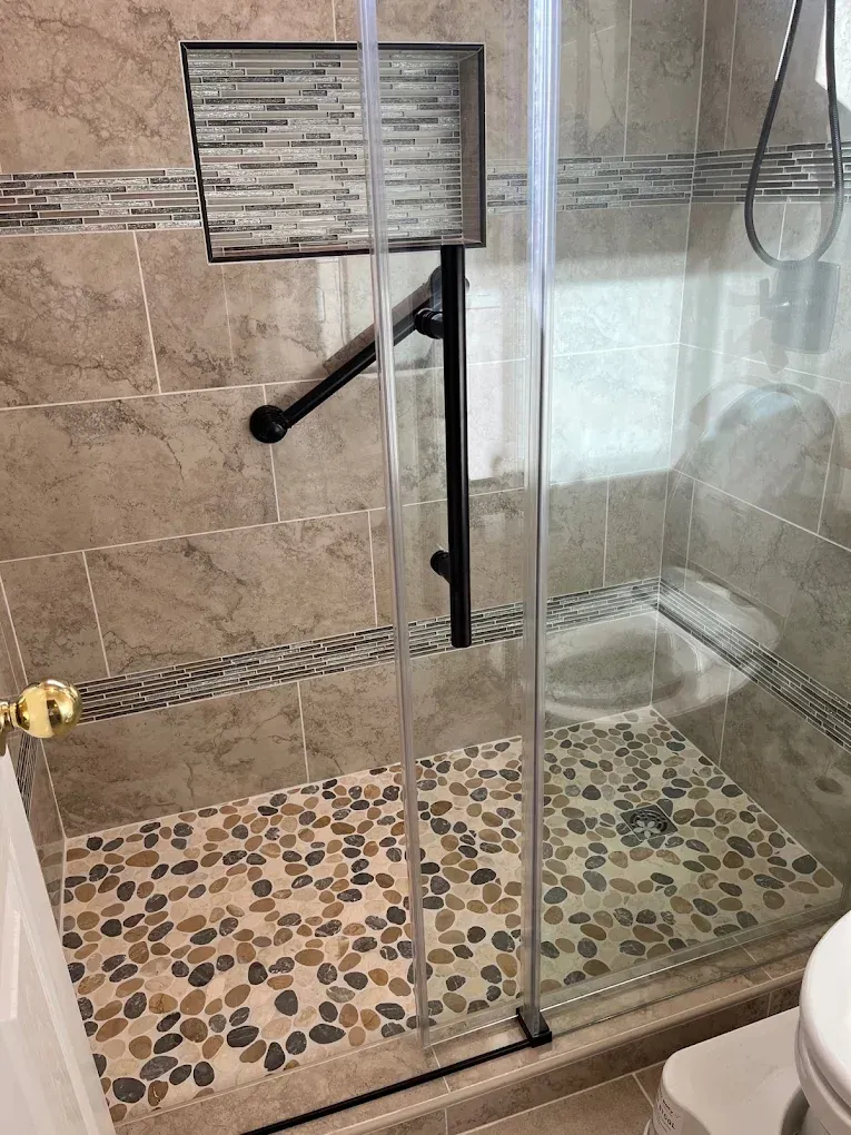 A bathroom with a walk in shower and a toilet.