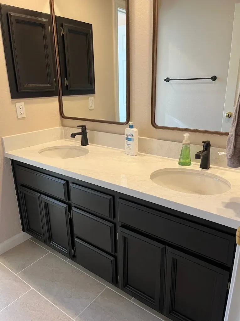 A bathroom with two sinks and two mirrors.