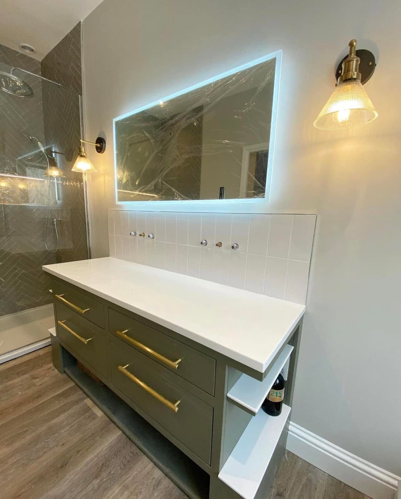 A bathroom with a large mirror and a sink.