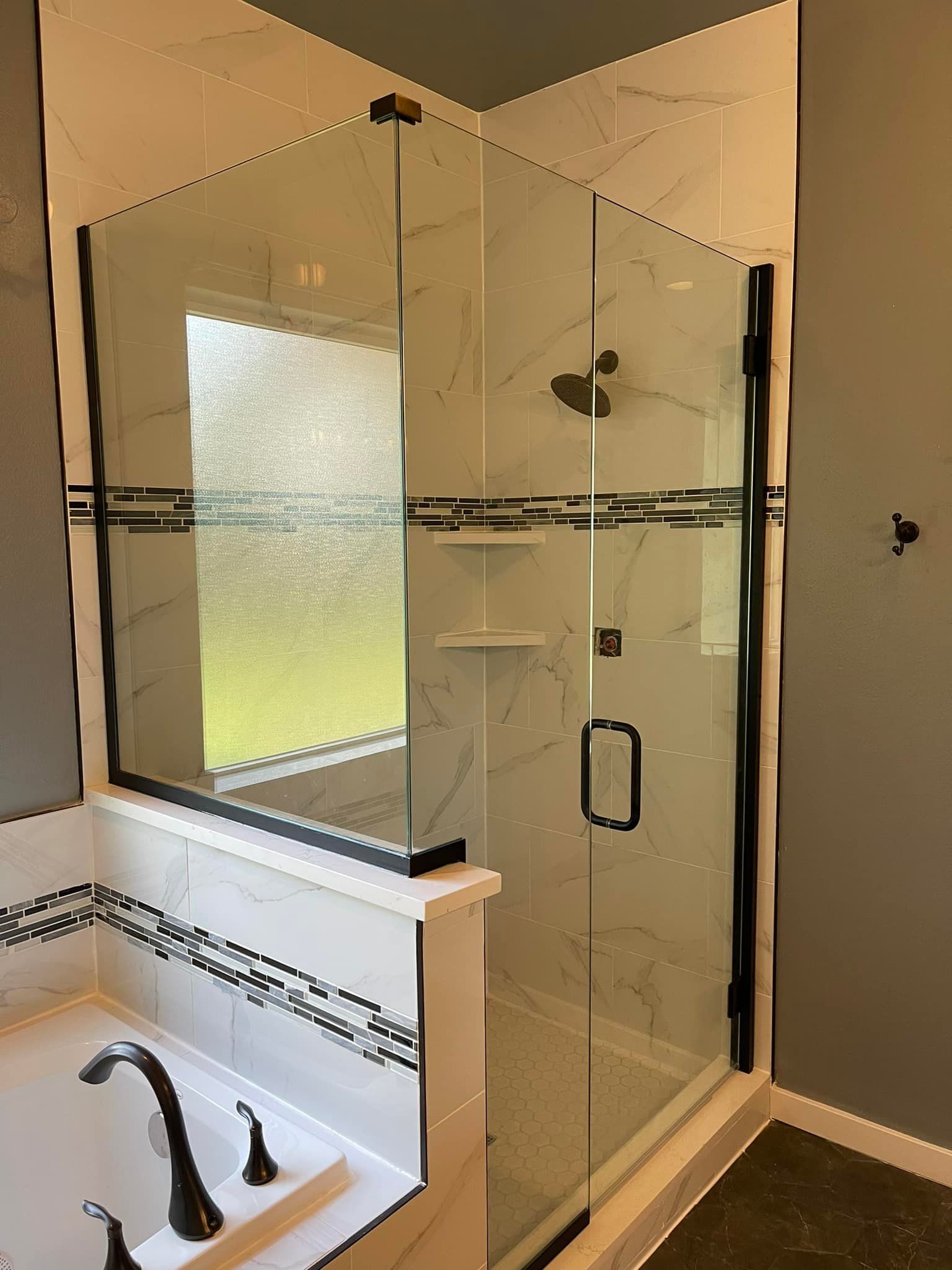 A bathroom with a walk in shower and a bathtub.