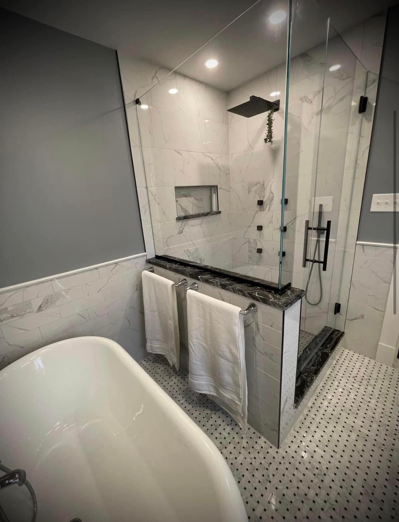 A bathroom with a bathtub and a walk in shower.