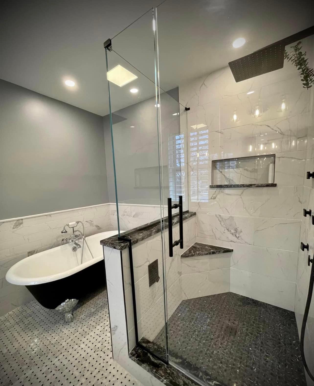 A bathroom with a tub and a walk in shower.