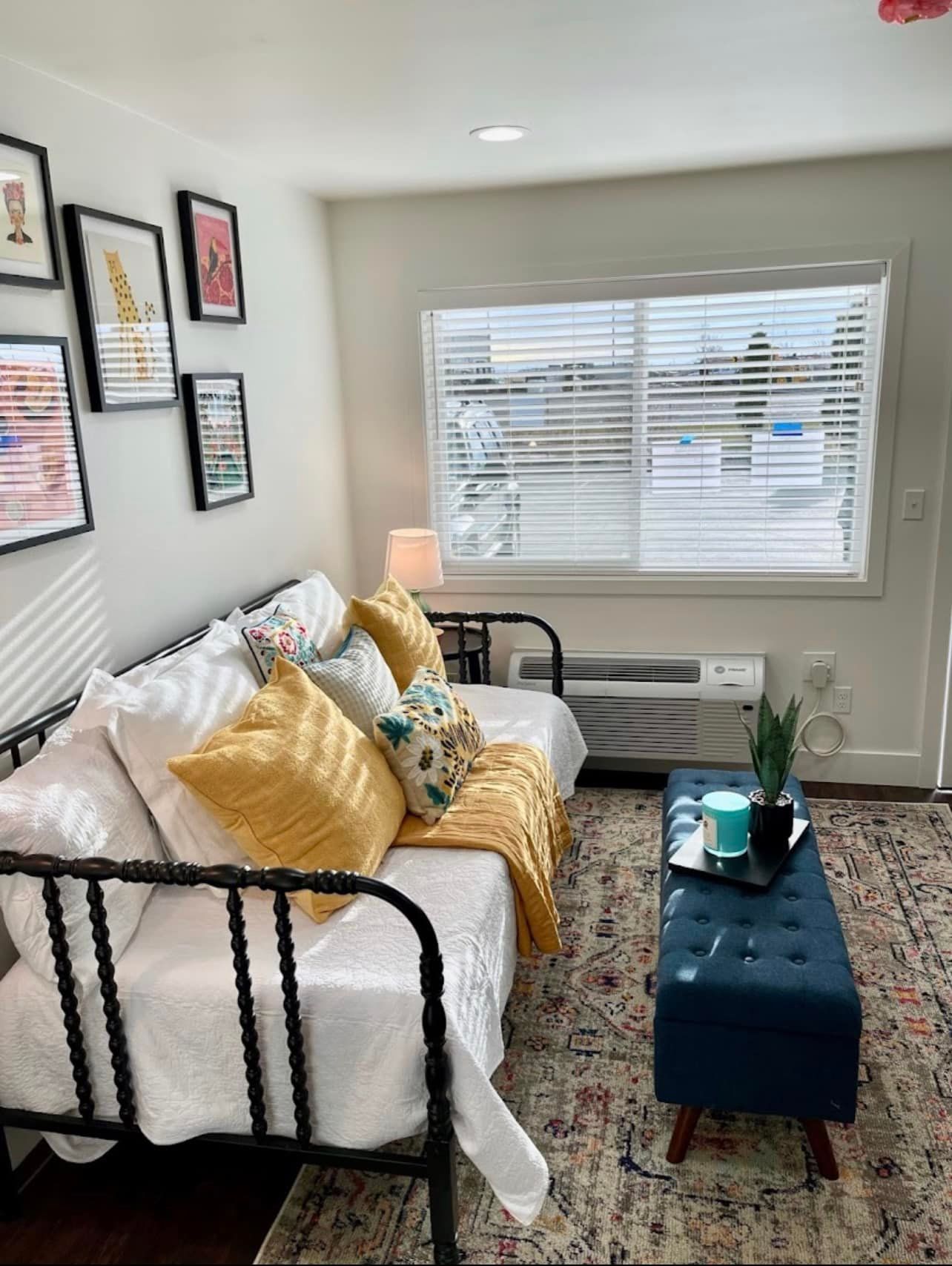 A living room with a couch , coffee table , and window.