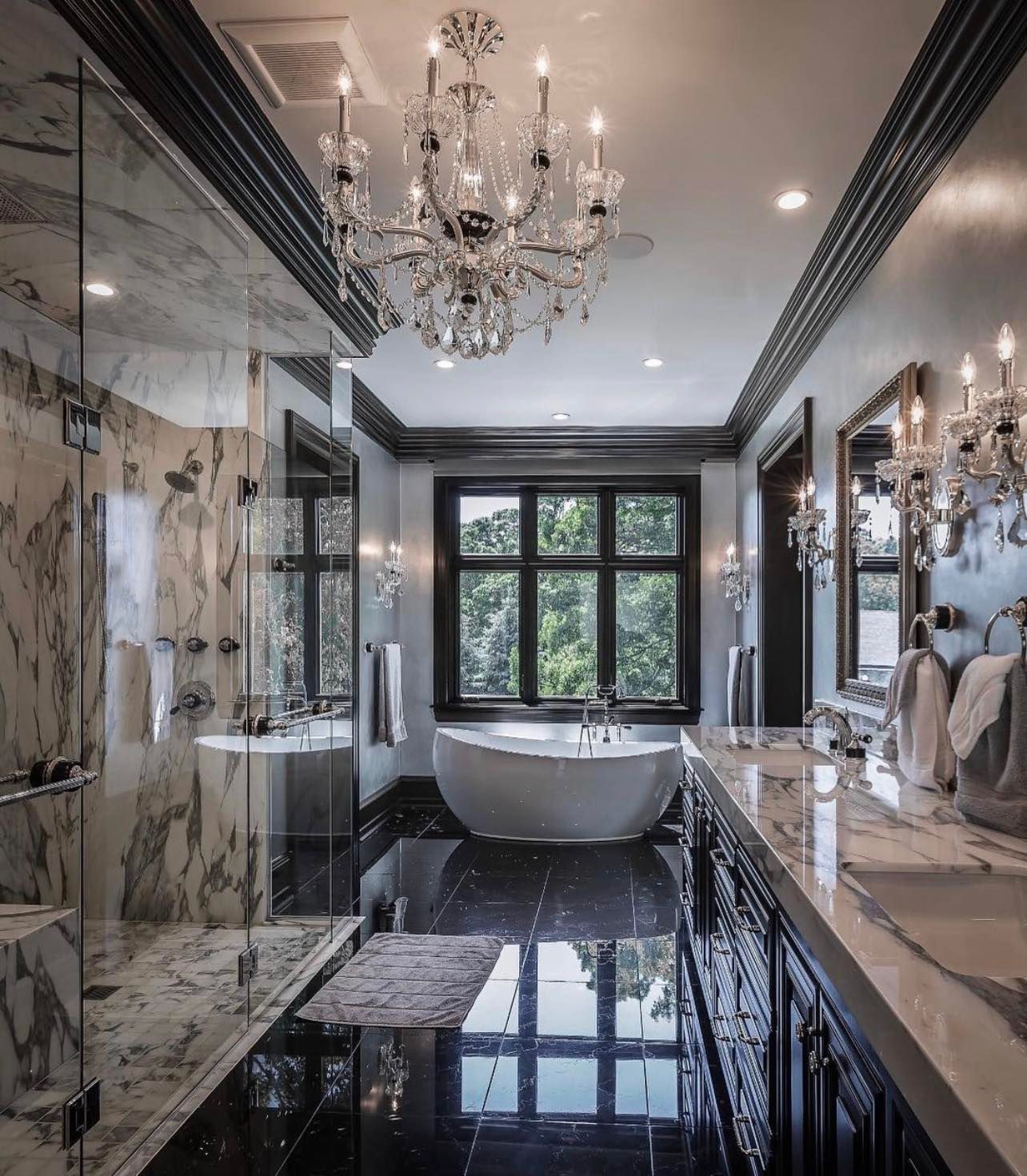 A bathroom with a bathtub and a chandelier hanging from the ceiling