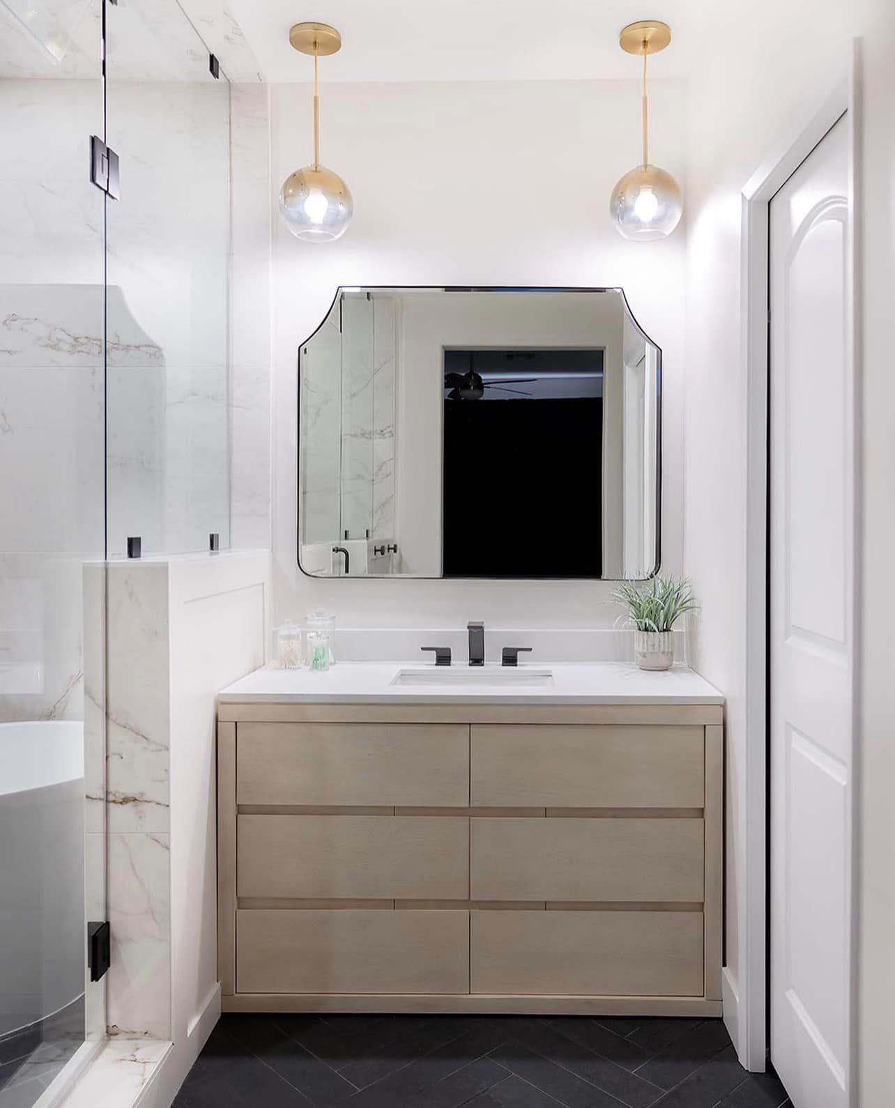A bathroom with a sink , mirror and dresser.