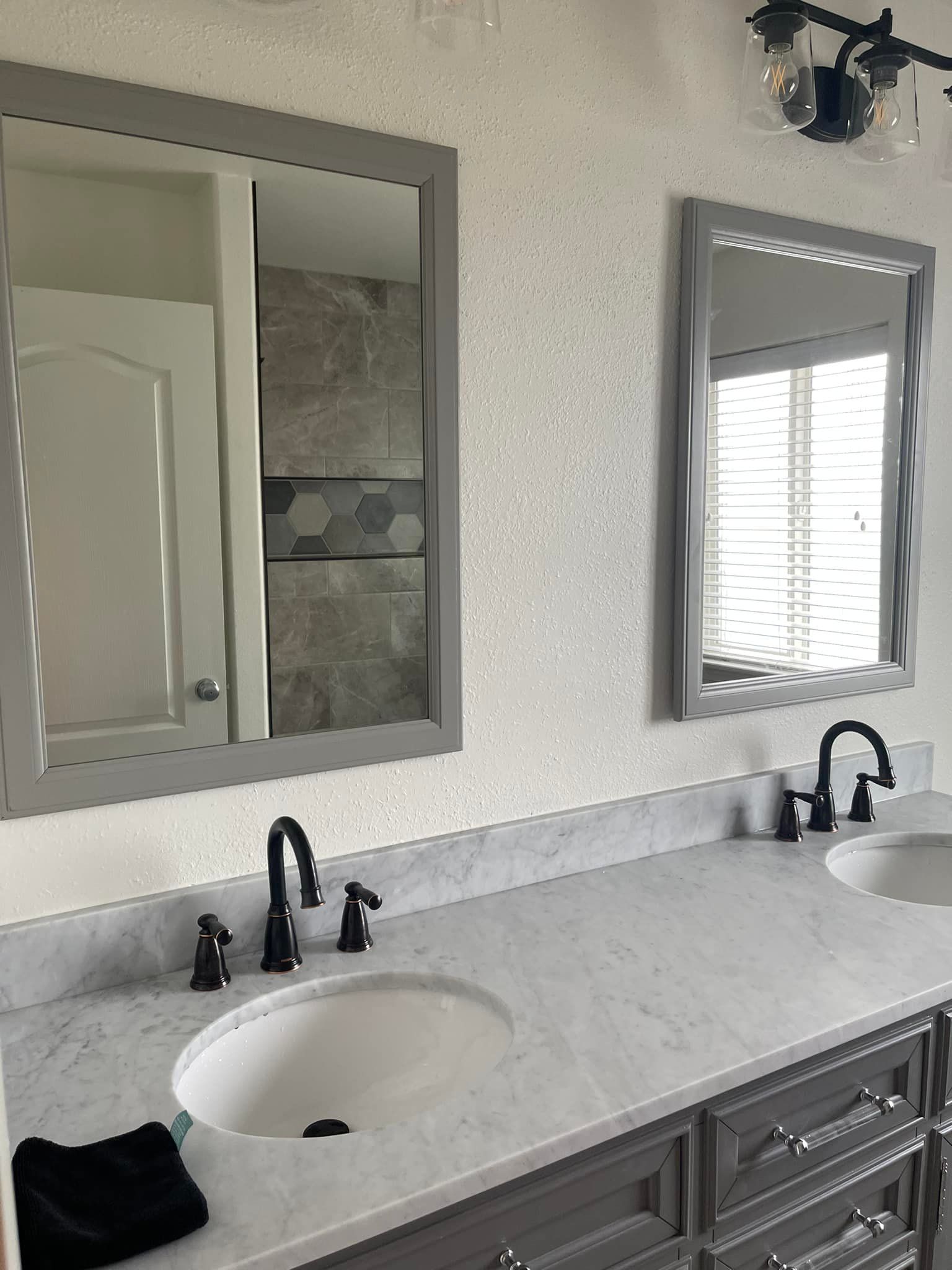 A bathroom with two sinks and two mirrors.