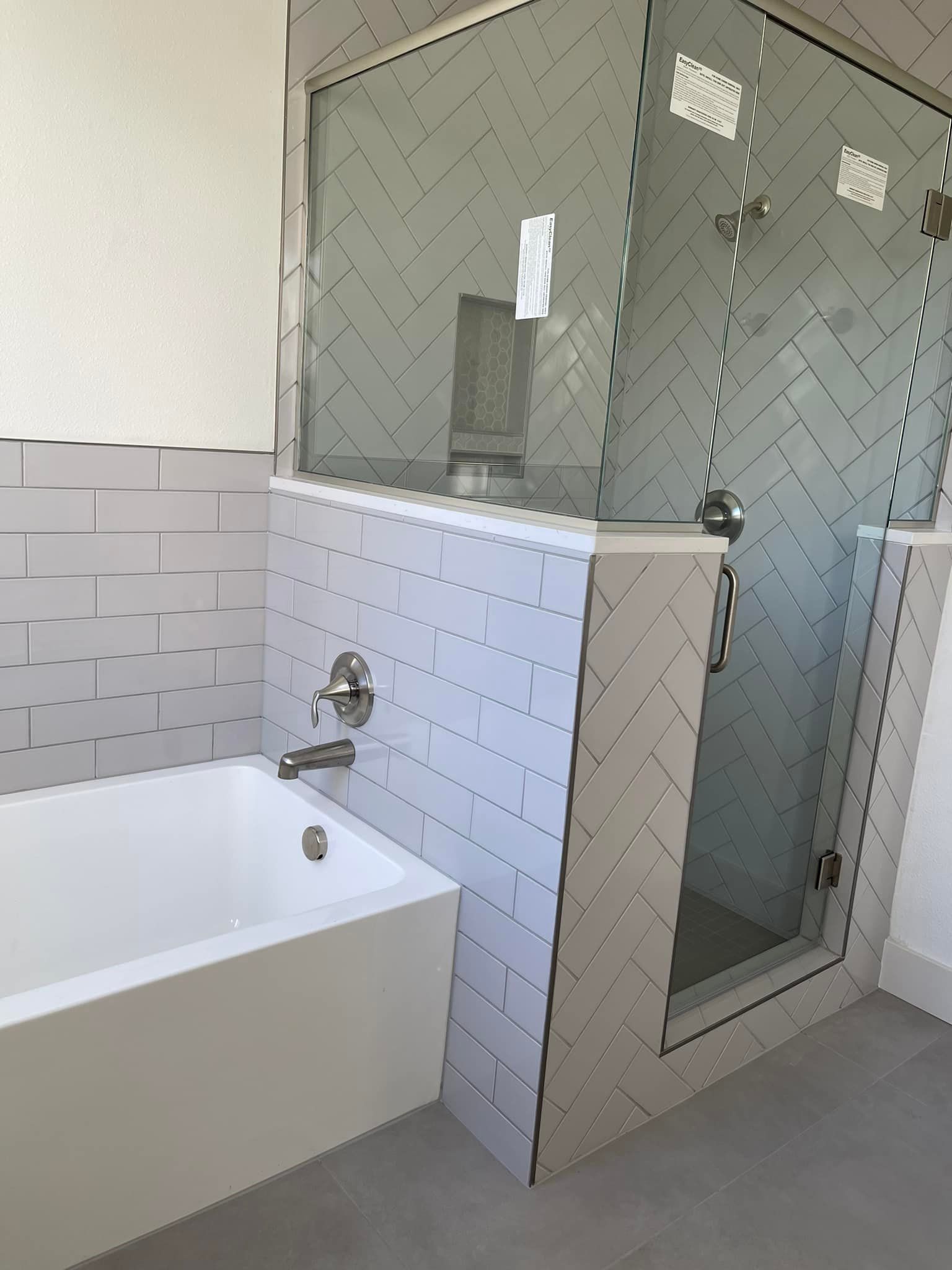 A bathroom with a bathtub and a walk in shower.