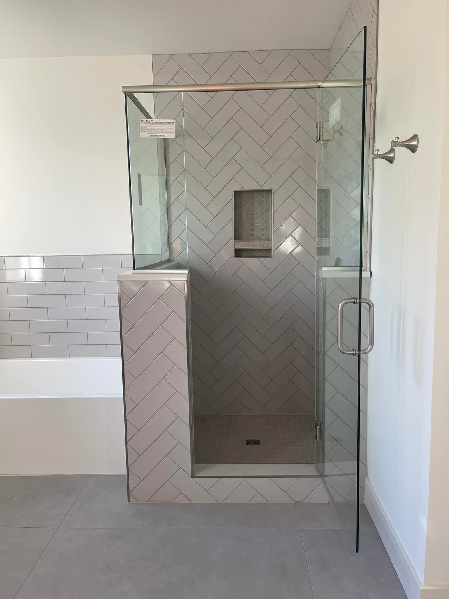 A bathroom with a walk in shower and a bathtub