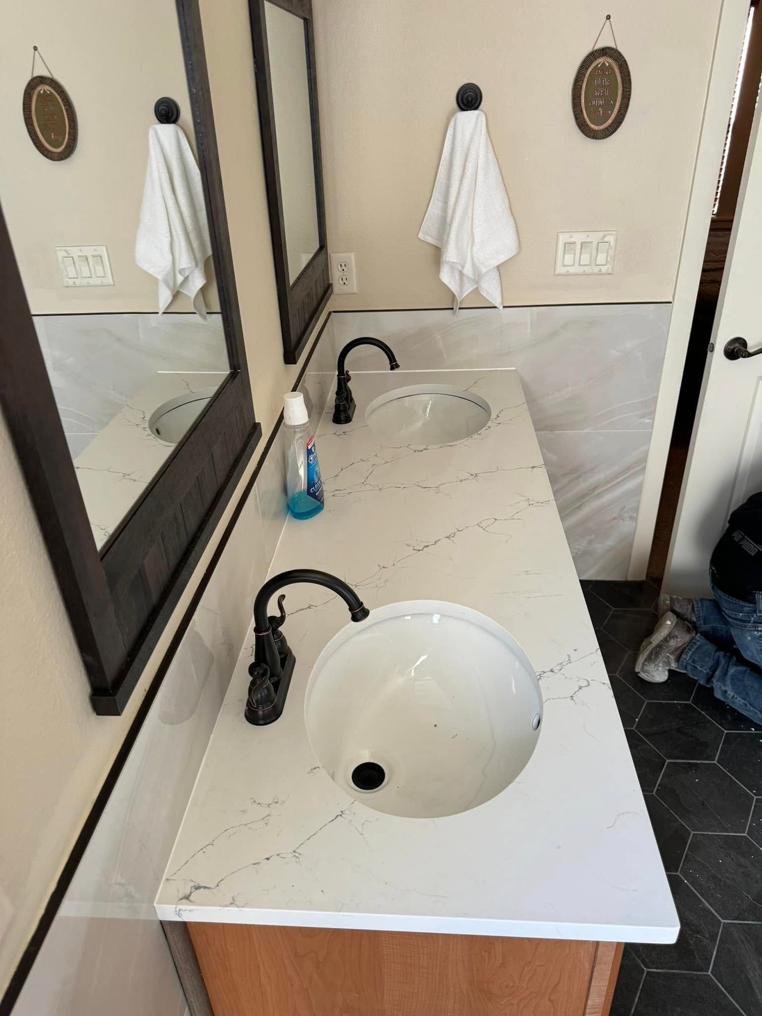 A bathroom with two sinks and two mirrors.