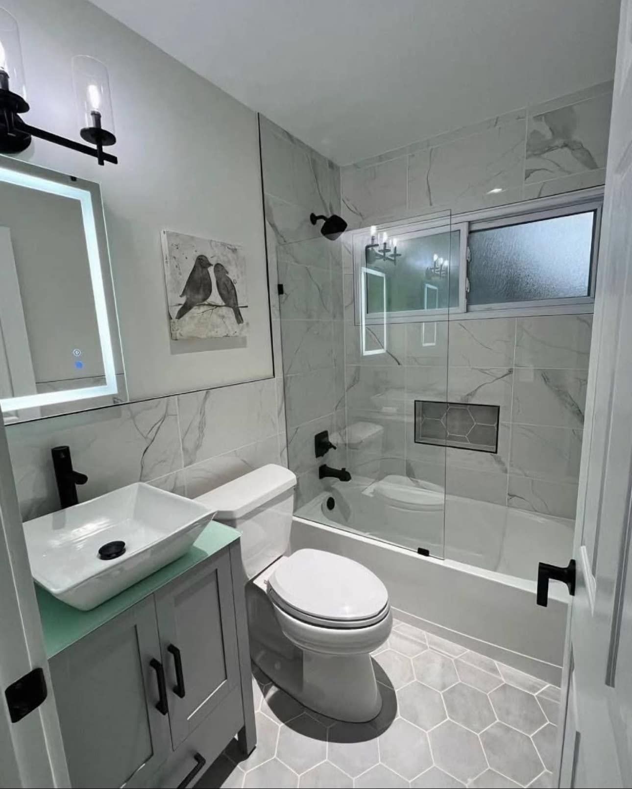 A bathroom with a toilet , sink , and bathtub.
