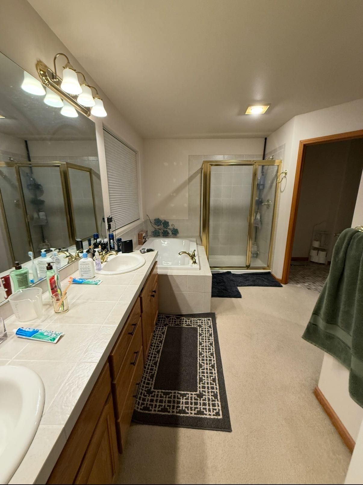 A bathroom with two sinks , a bathtub and a shower.