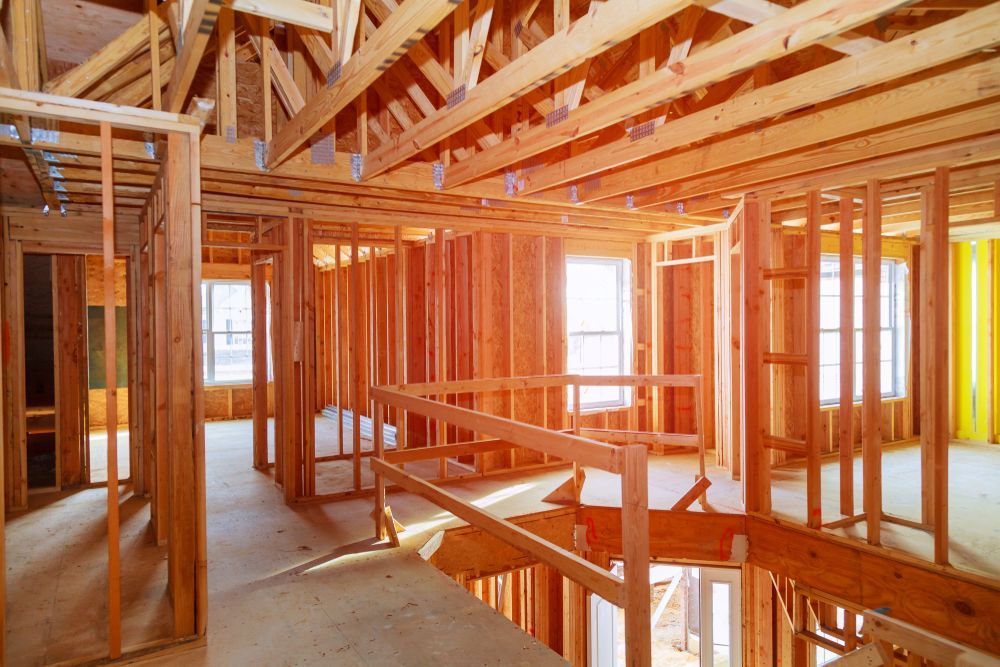 The inside of a house that is being built with wooden frames.