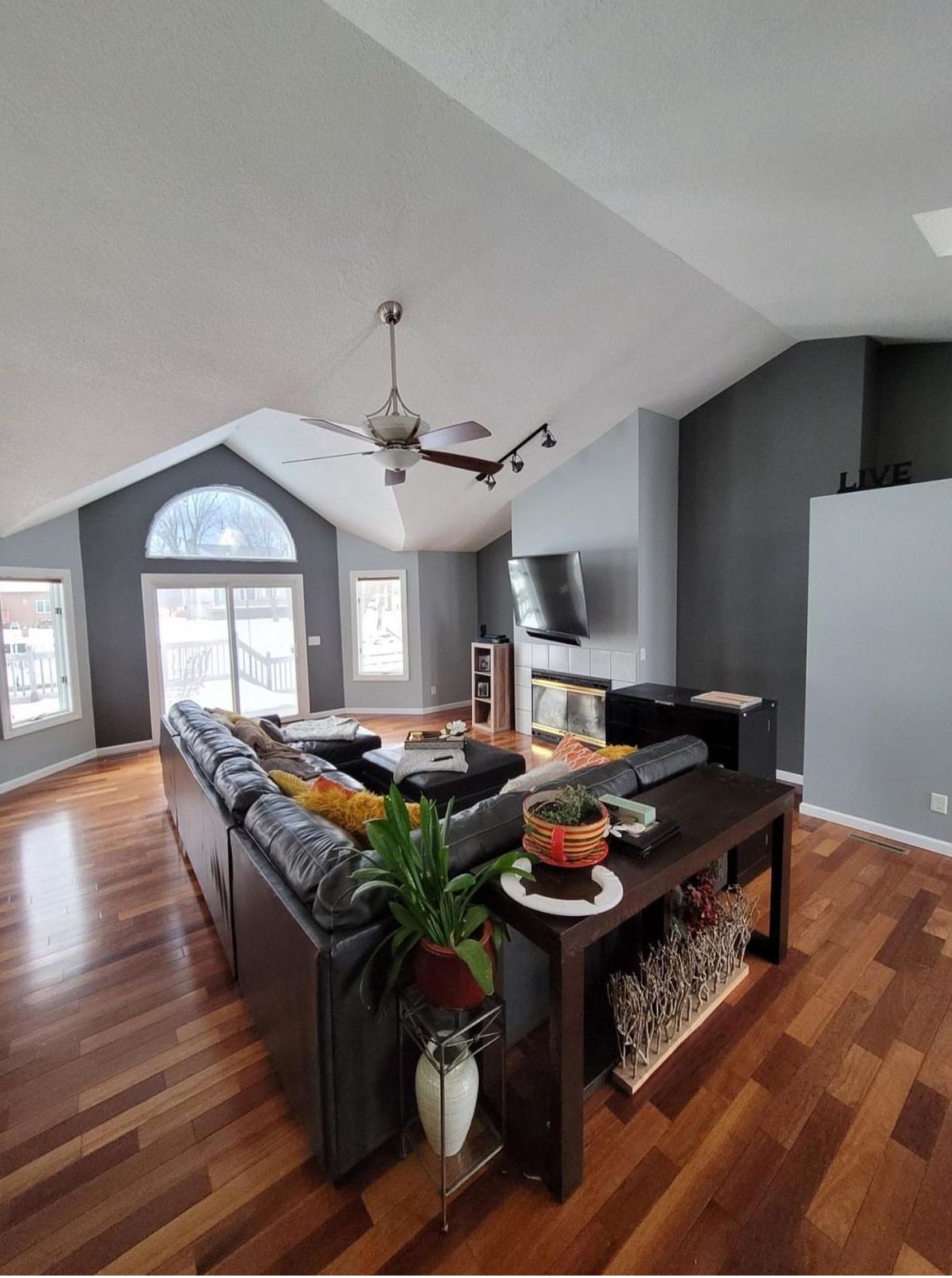 A living room with a large sectional couch and a coffee table