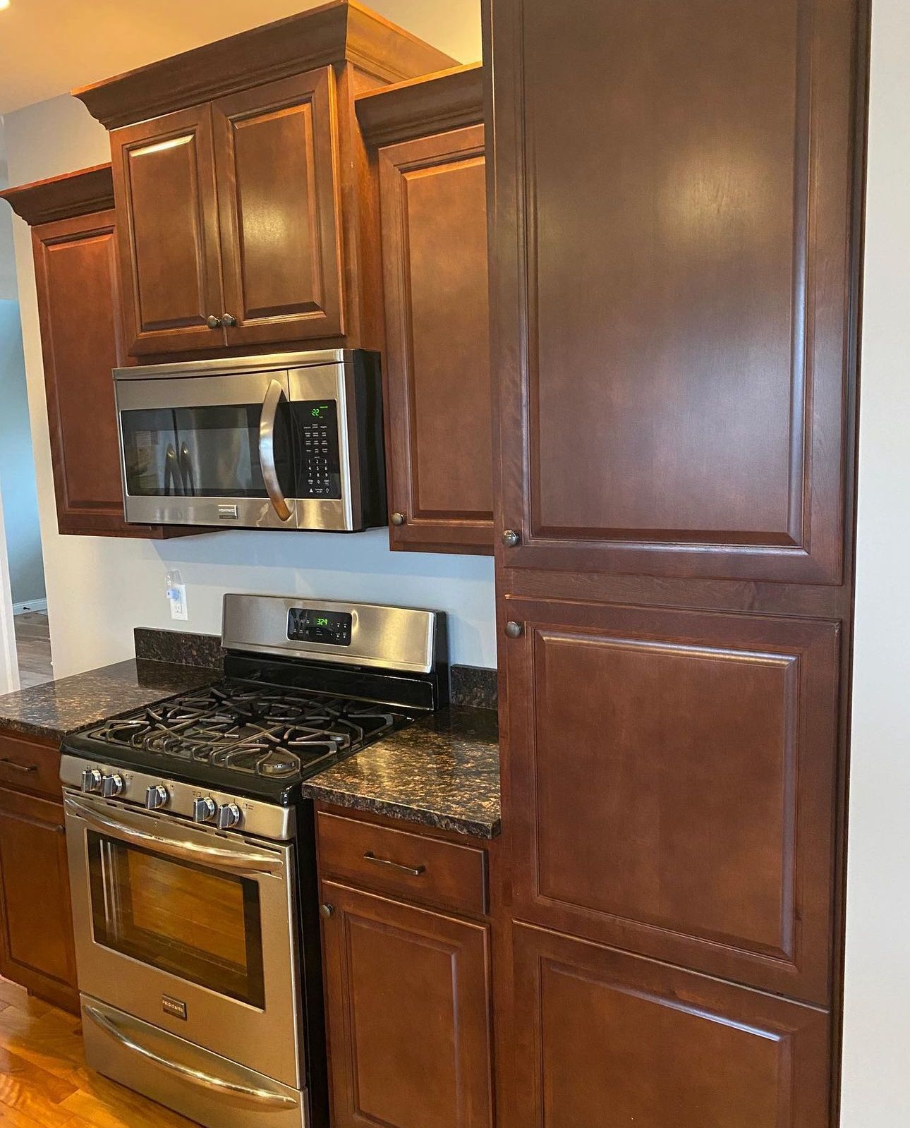 A kitchen with stainless steel appliances and wooden cabinets