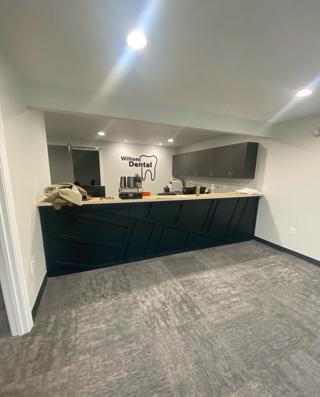 A living room with a couch , table , television and ceiling fan.