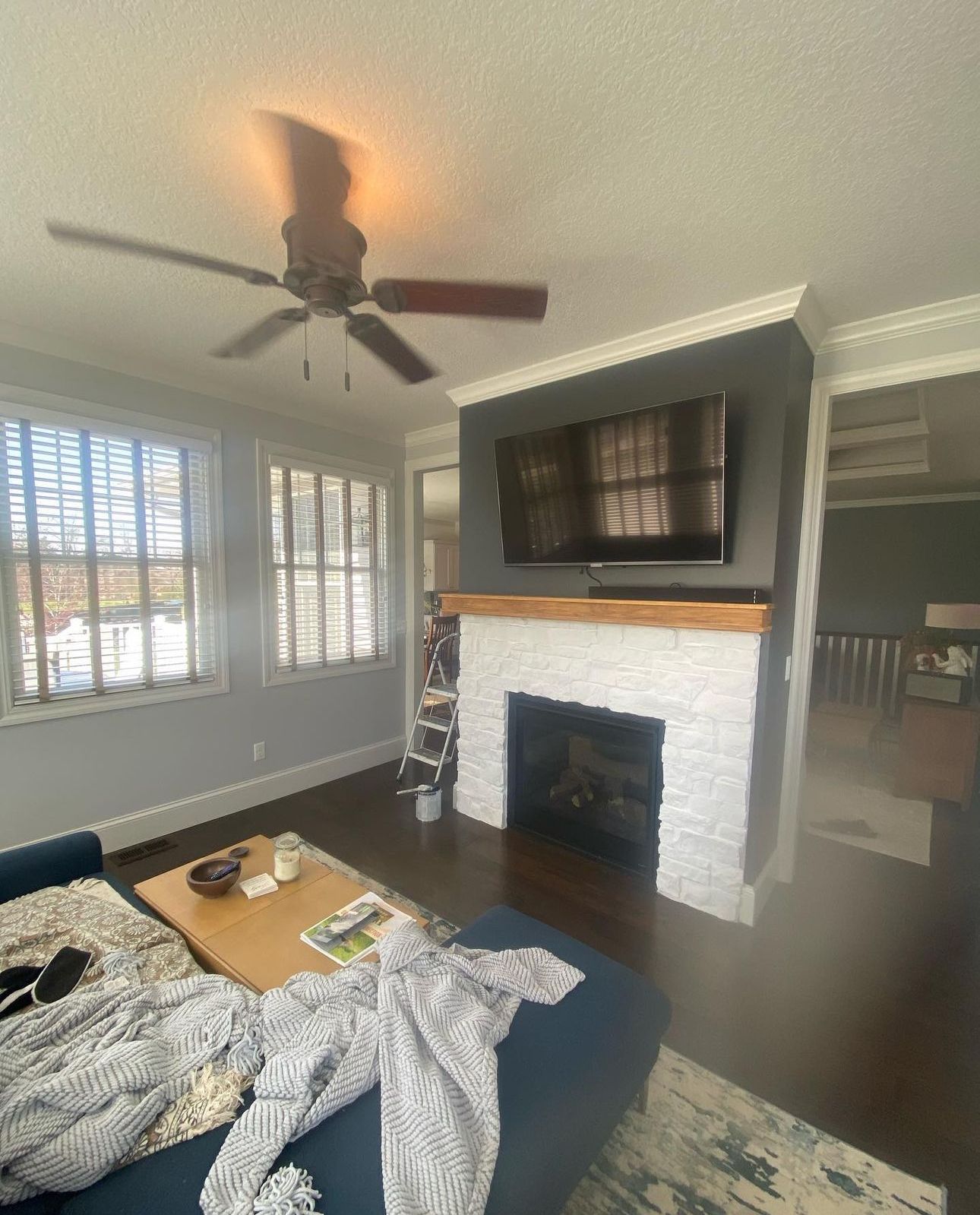 A kitchen with white cabinets and a wooden floor.