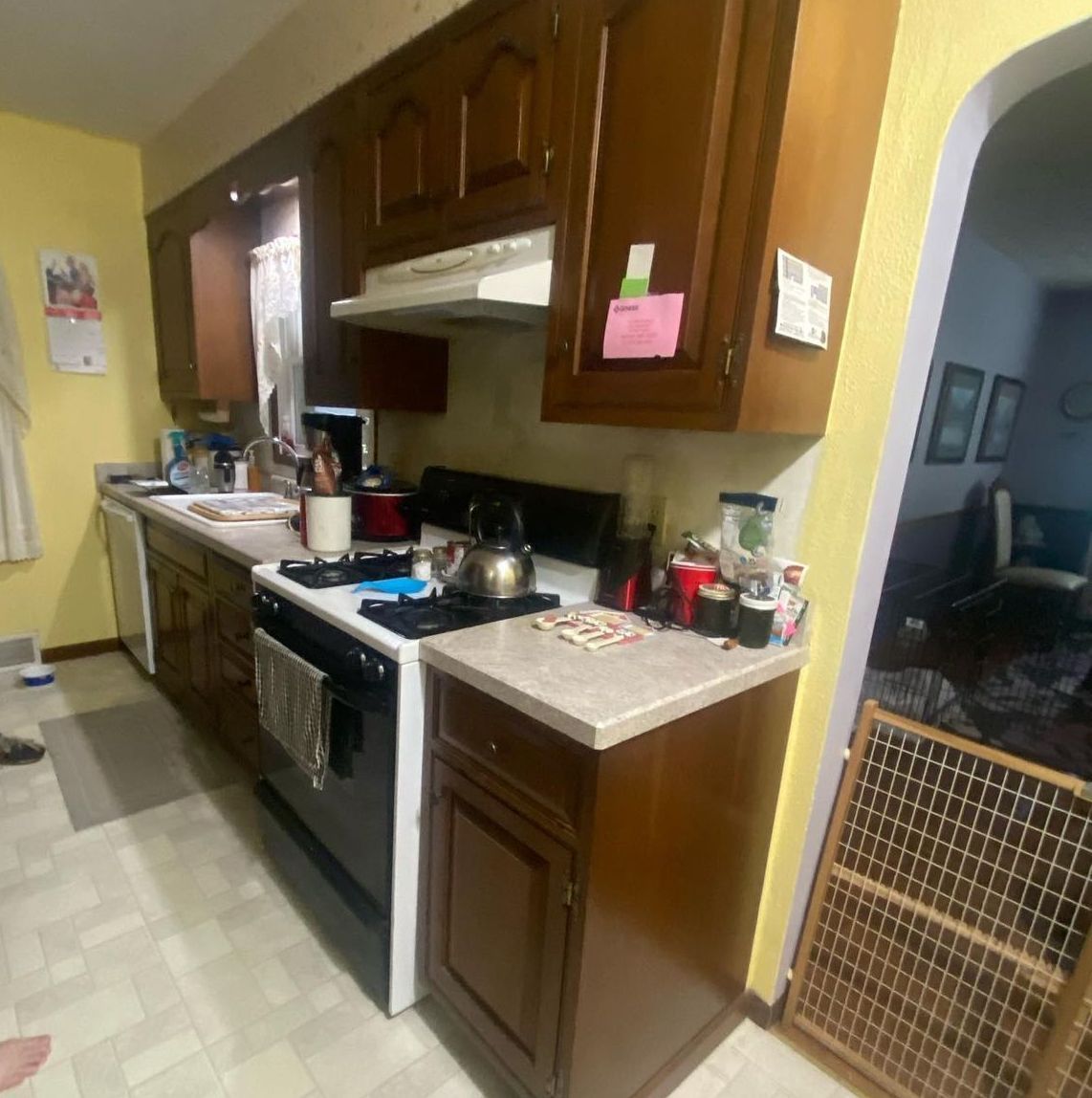 A kitchen with wooden cabinets and a stove top oven