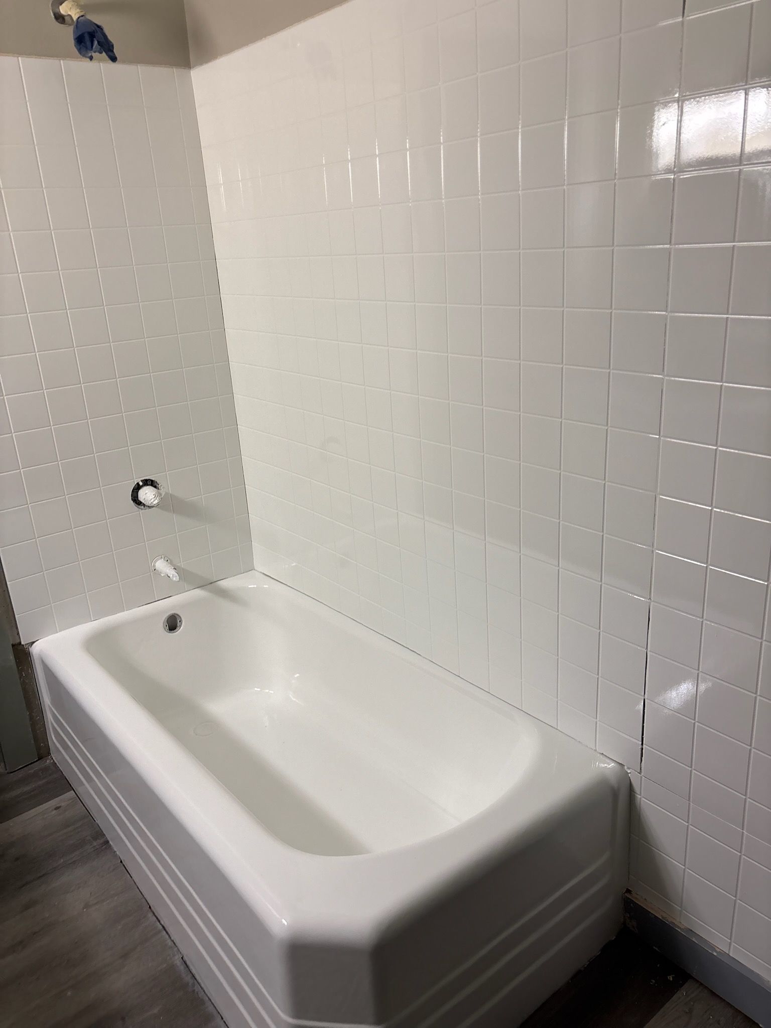 A large white house with a porch and a walkway in front of it.