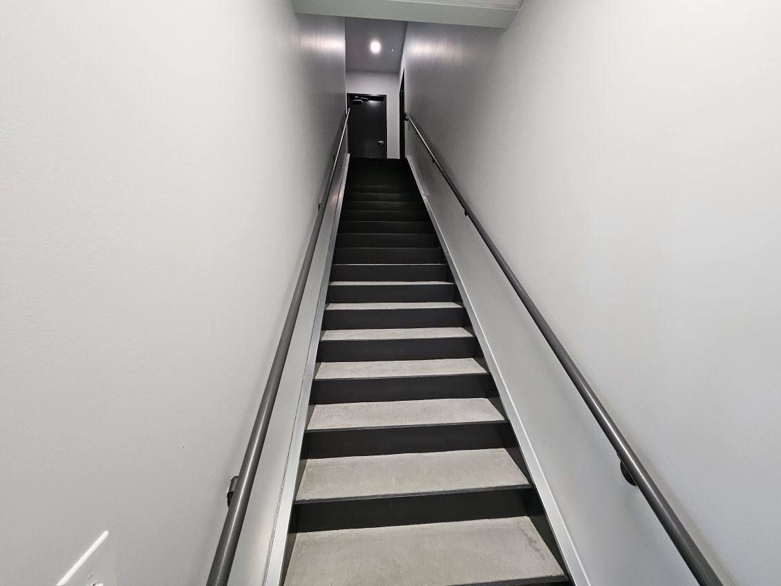 A set of stairs leading up to a doorway in a building.