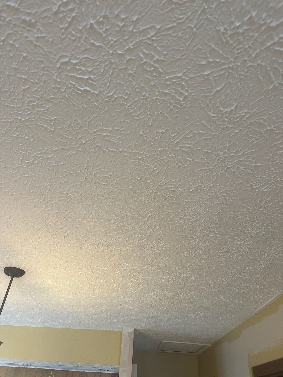 A close up of a white ceiling in a room.